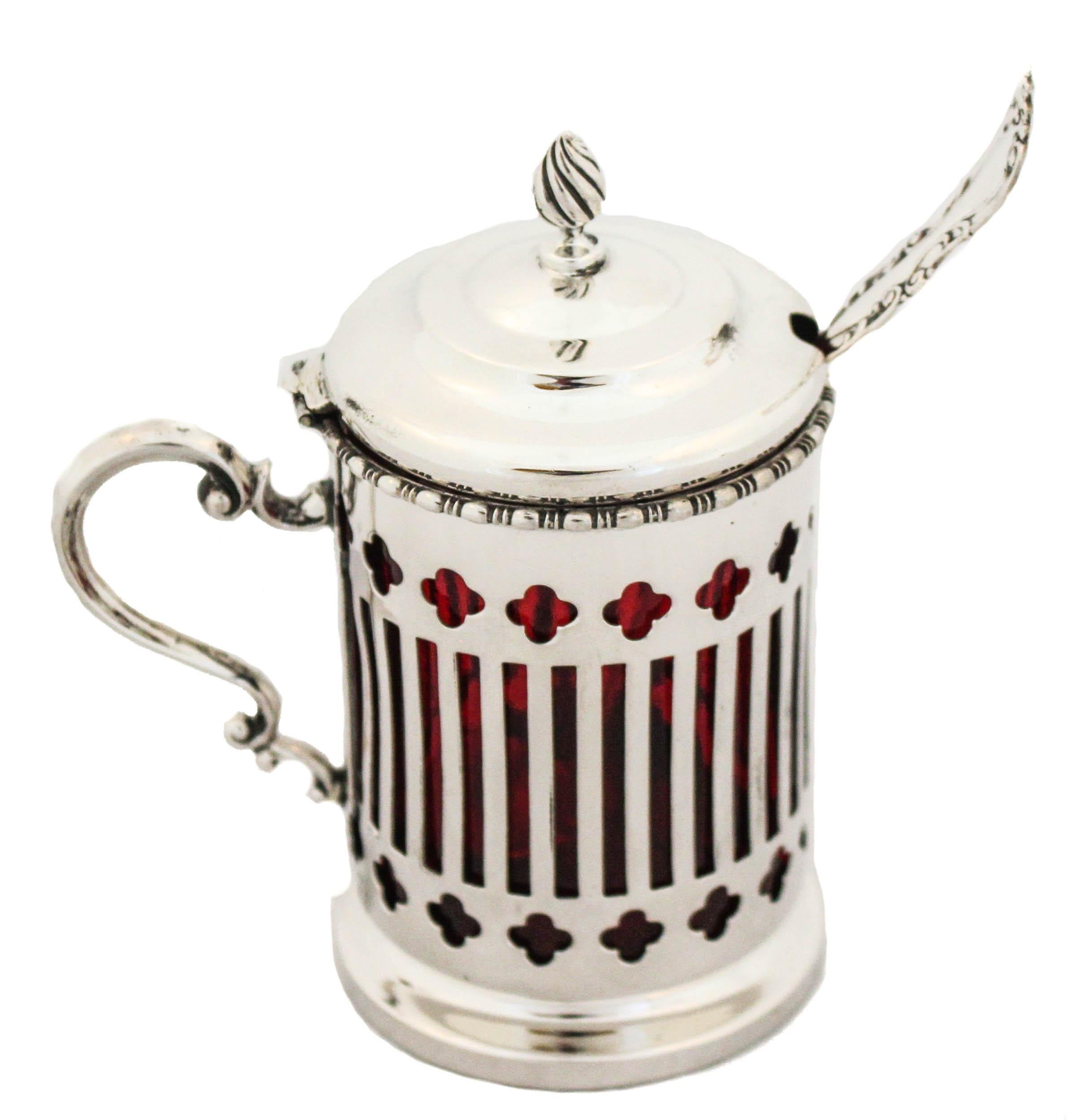 This rare sterling silver mustard jar and ladle were manufactured by Marcus & Company.  It has a ruby-red glass liner that pops through the reticulated pattern.  The glass is removable so it’s super easy to wash and return.  The mustard ladle has a