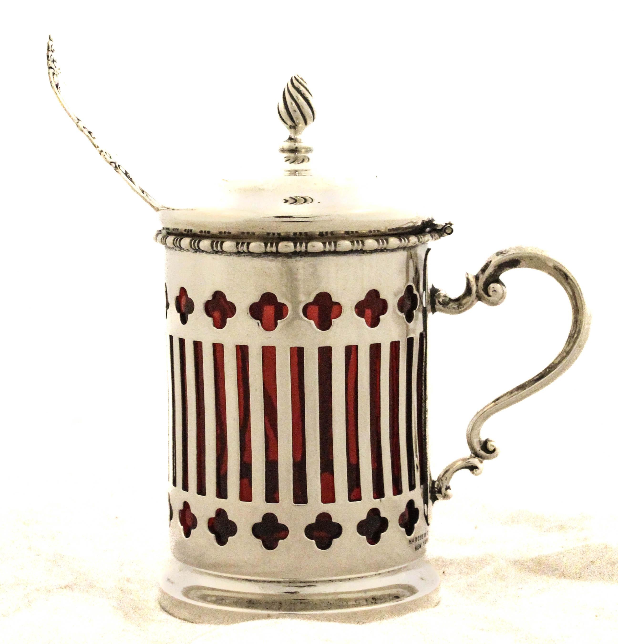 A refined sterling silver mustard jar and matching ladle crafted by Marcus & Company of New York, a distinguished American jeweler and silversmith active during the late 19th and early 20th centuries. The jar features an intricate reticulated design