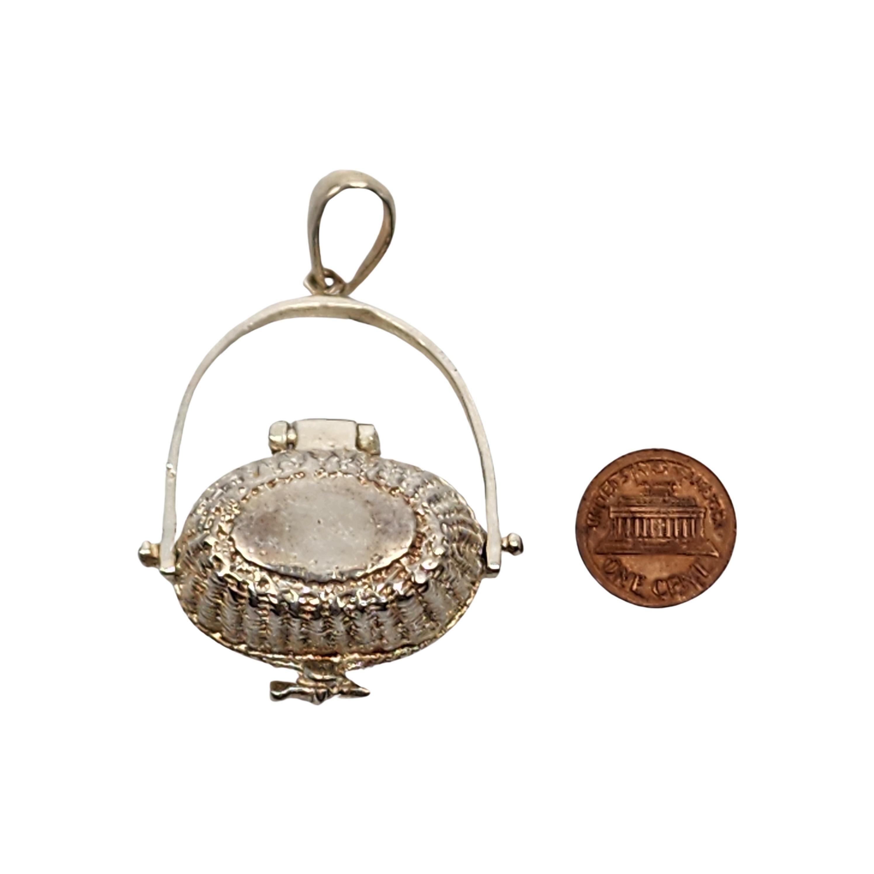 Sterling silver Nantucket Basket pendant with lucky penny.

A beautifully detailed basket with a lucky penny inside. The lid features a Nantucket lighthouse scene. The penny is part of a Nantucket legend that says throwing a penny into the sea while
