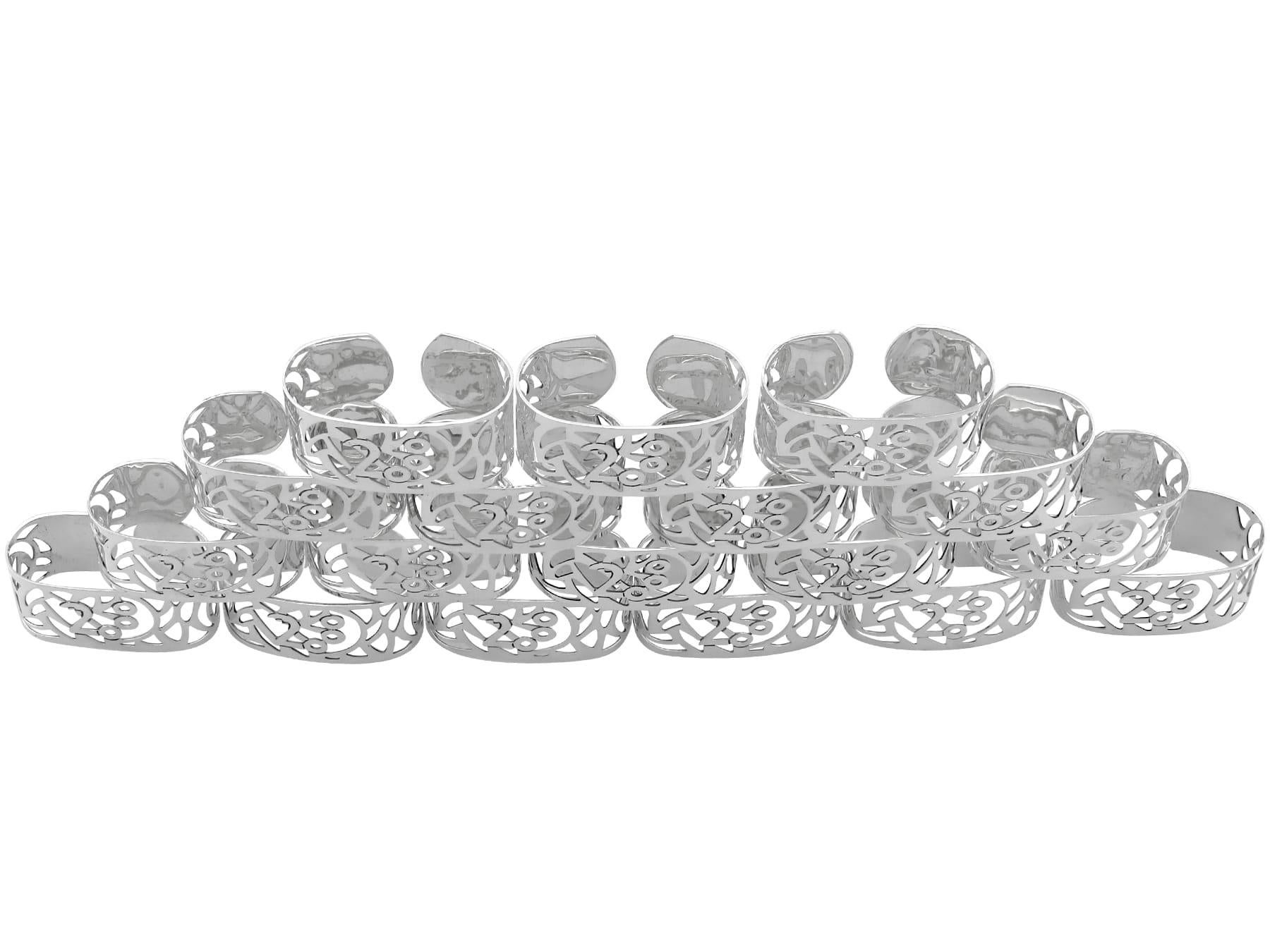 An exceptional, fine and impressive set of eighteen contemporary Elizabeth II English sterling silver millenium napkin rings; part of our dining silverware collection.

These exceptional contemporary English sterling silver napkin rings have a