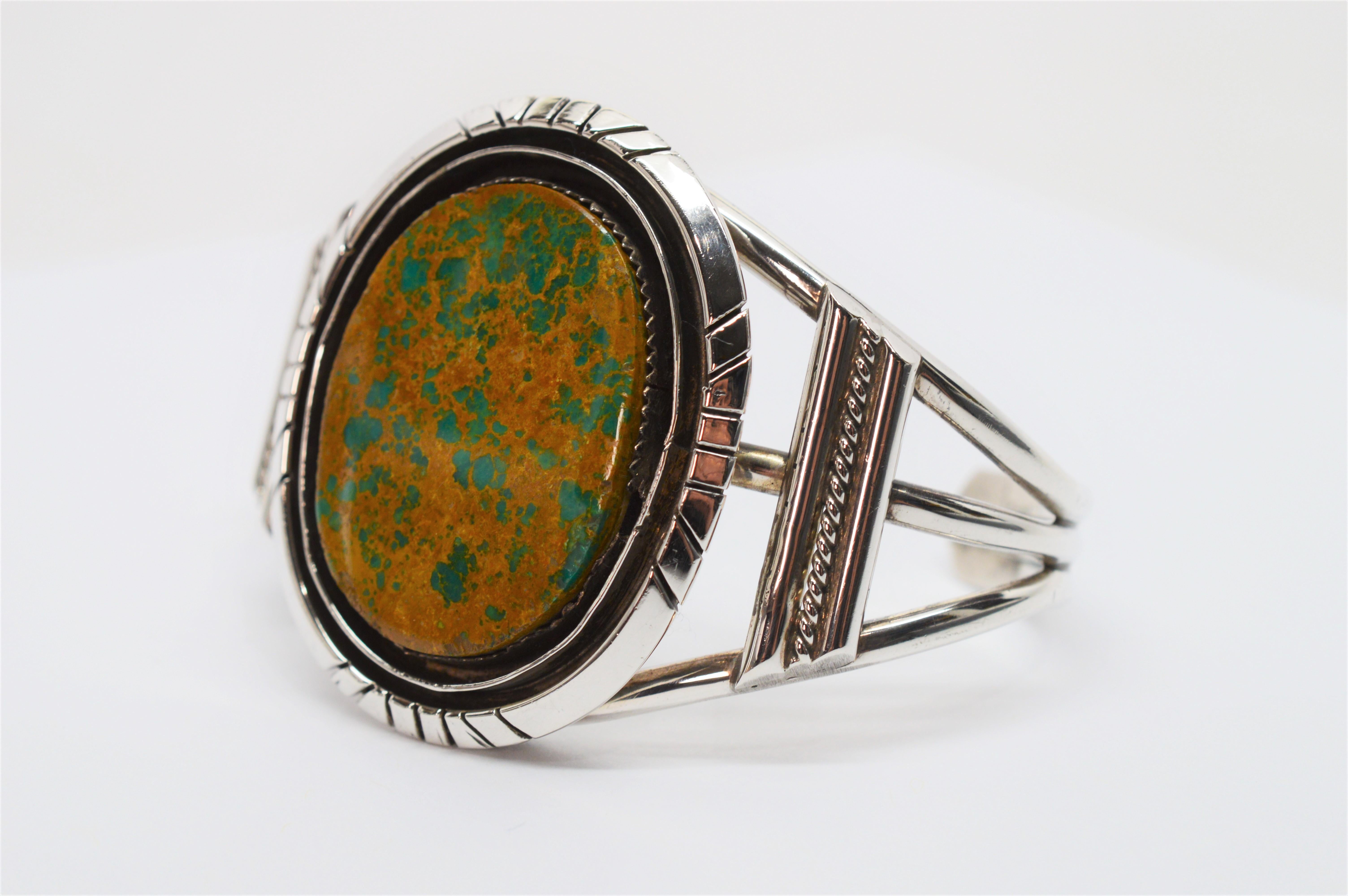 Artisan crafted in sterling silver, this Southwest style cuff bracelet is purposely designed to showcase the earthy warm tones of its large 34 x 26mm oval unakite stone. Known as a stone of vision and balance among healing practitioners, this