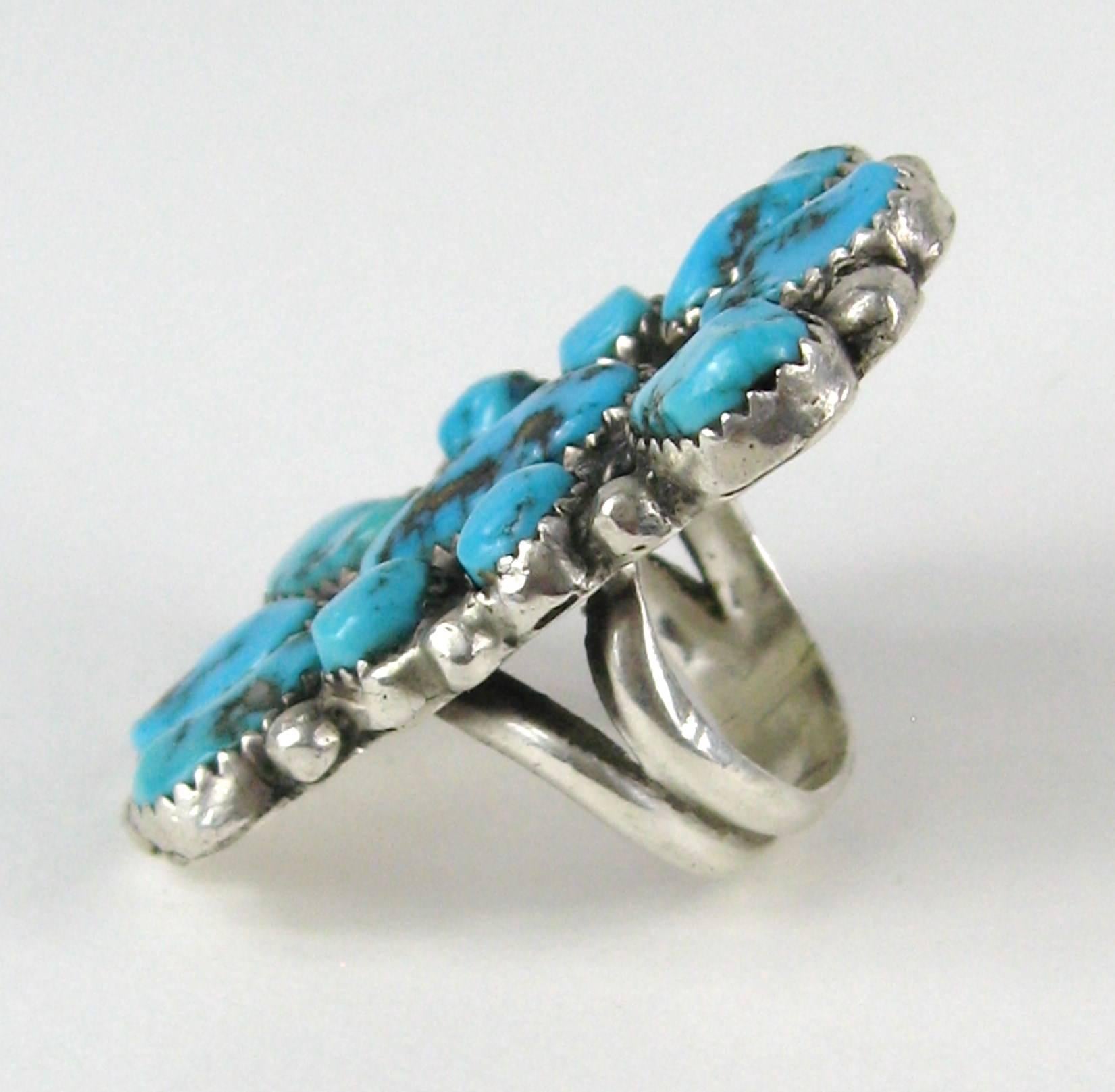 This is massive in size with Nuggets of Turquoise set in Sterling Silver. It is Hallmarked inside Ring. Measuring 1.75 in top to bottom x 1.12 in wide. It is a Size 4.25. This is out of a massive collection of Hopi, Zuni, Navajo, Southwestern and