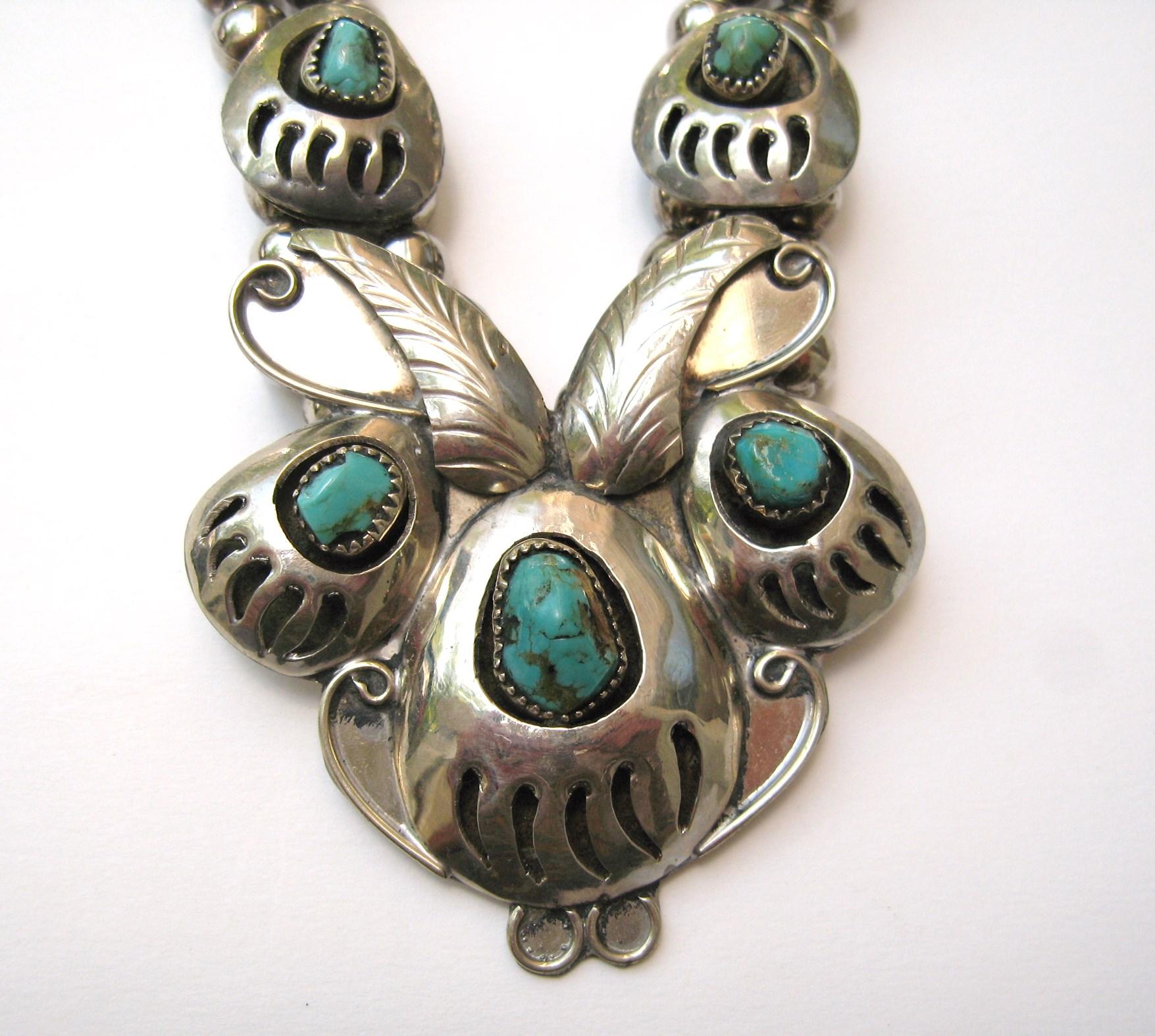Bear Claw shadowbox Squash Necklace. 9 Inset Turquoise stones set in bear claws. Necklace Measures 22.5 end to end. The drop at the center is approximately 2.30 x 2.30 inches. Double beading graduating to a single bead chain. Hallmarked on the back.