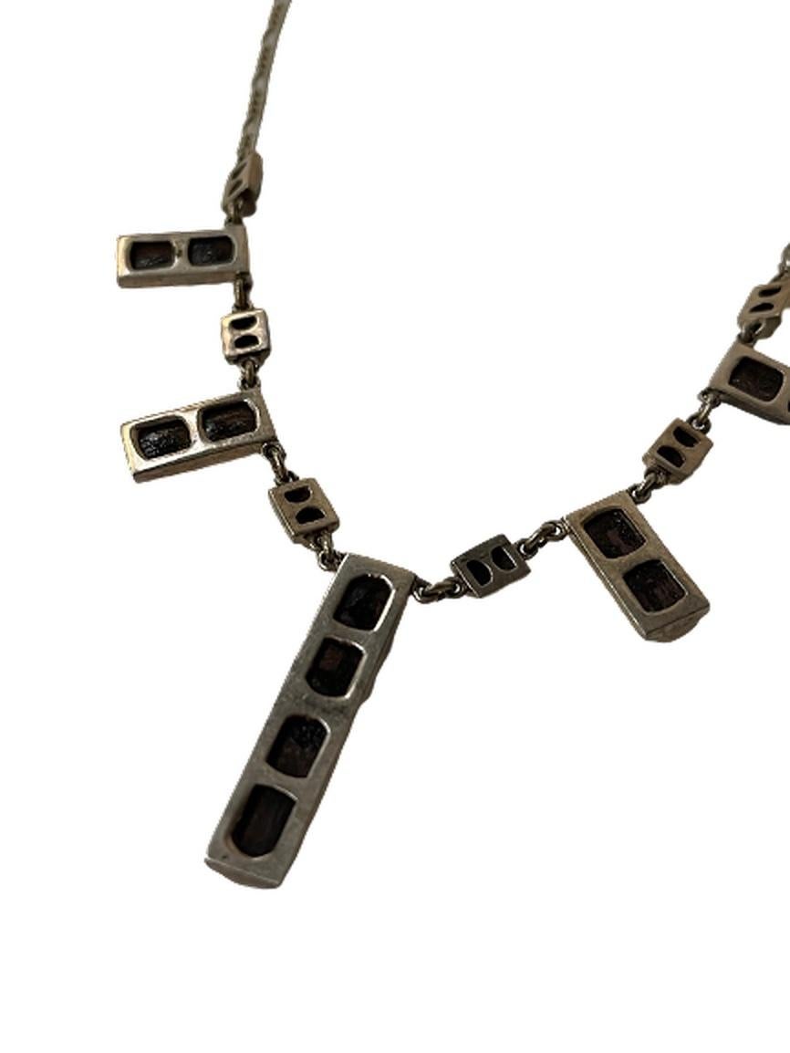 This is a sterling silver necklace with black charms.

The longest charm is 1.5