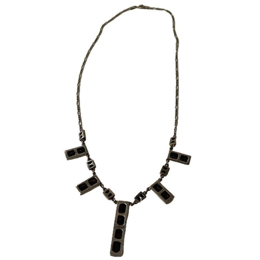 This is a sterling silver necklace with black charms.

The longest charm is 1.5