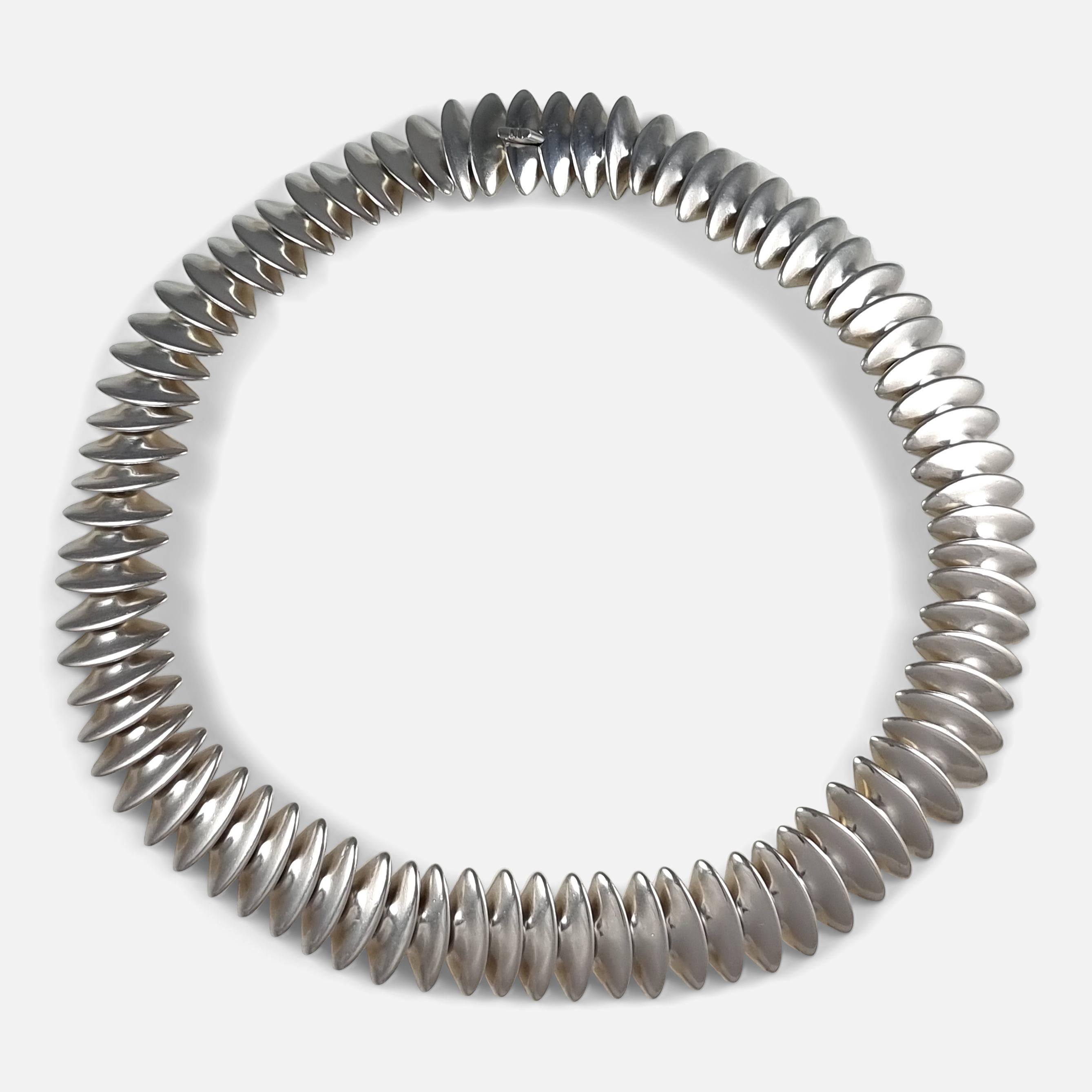 A sterling silver necklace, by Hans Hansen for Georg Jensen.

The necklace was originally designed by Bent Gabrielsen for Hans Hansen, before the firm of Hans Hansen was taken over by Georg Jensen.

The necklace is stamped with the Georg Jensen