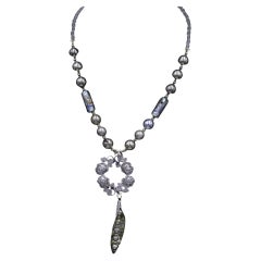 Sterling silver necklace of vintage brooches,sterling beads and Murano glass .