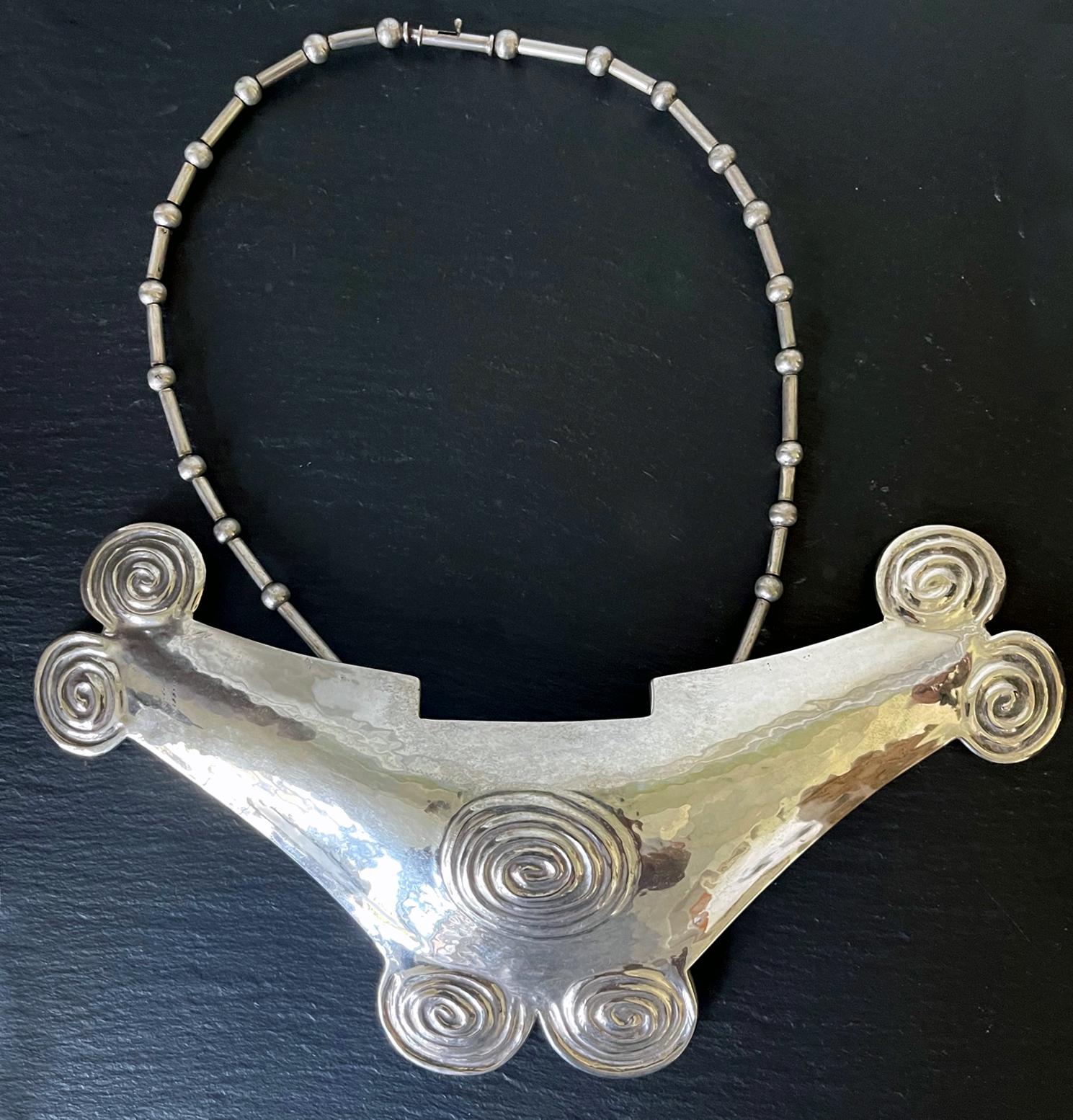 A stunning choker style necklace in sterling silver by Graziella Laffi (1926-2009) Lima, Peru, circa 1960s. The bold necklace showcases an oversized plate pendent in a bird-like form reminiscent of those found in Pre-Columbian cultures such as