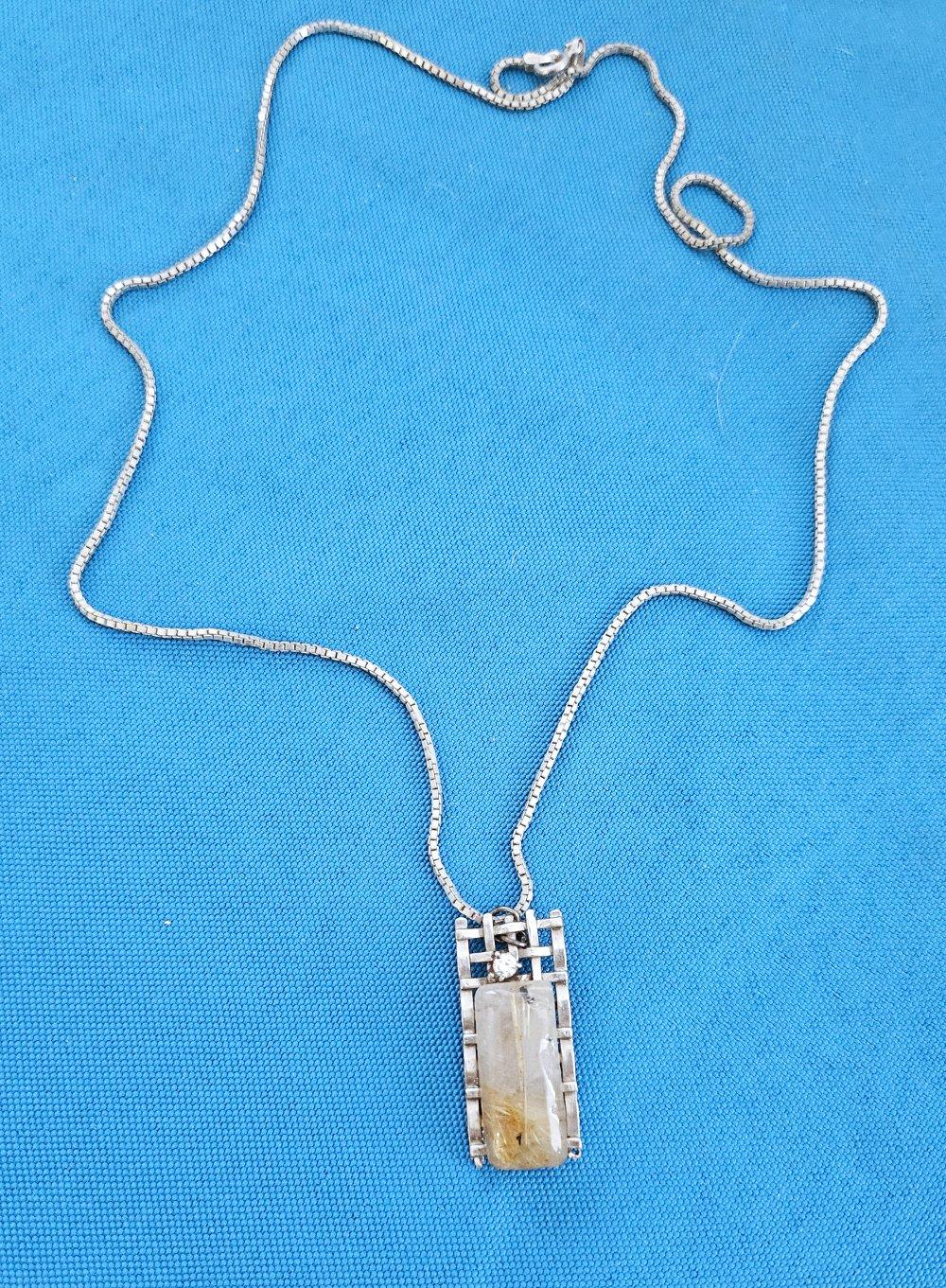 Sterling Silver Necklace with Rutilated Quartz Pendant
UPDATE: Due to agreement with 1stDibs, we'll be staying through the end of the year.
This is a lovely, unique pendant necklace! The chain is stamped 925 and we estimate it to be 20 or so inches