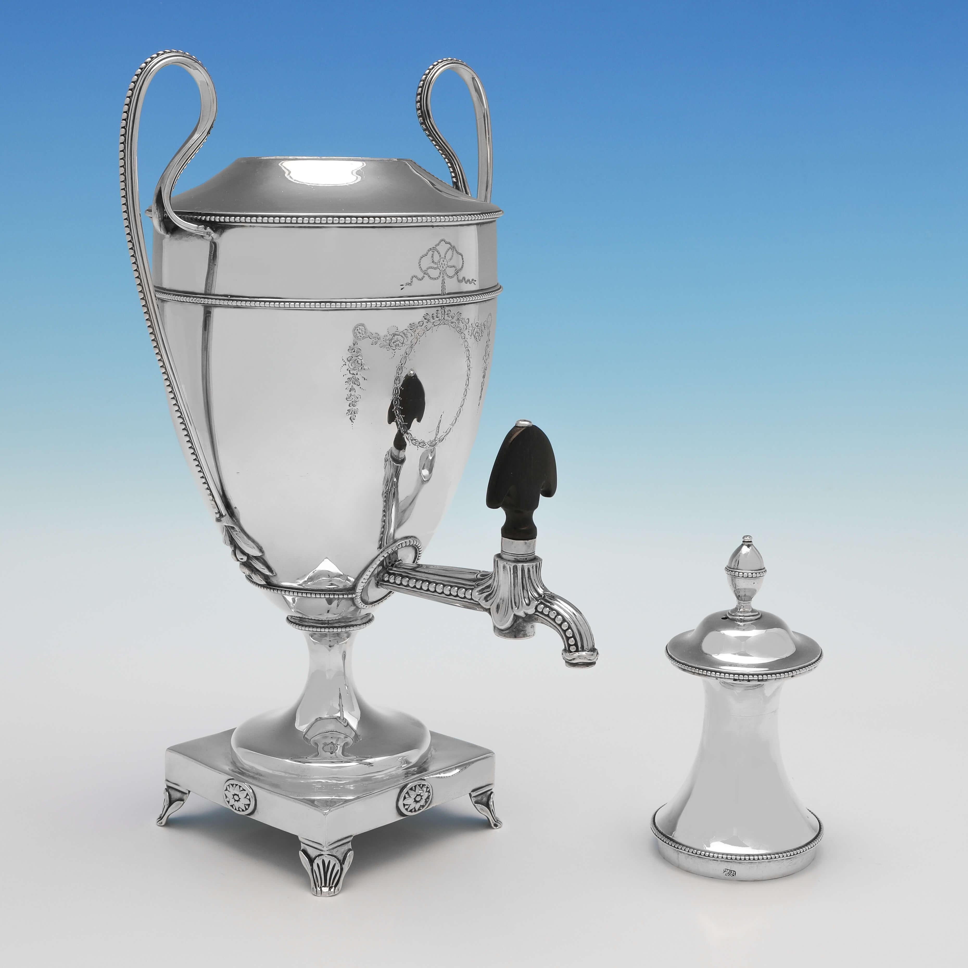Hallmarked in London in 1780 by Hester Bateman, this handsome George III, Antique Sterling Silver Tea Urn, is in the Neoclassical taste, with bright cut engraved decoration and bead borders. The tea urn measures 14.25