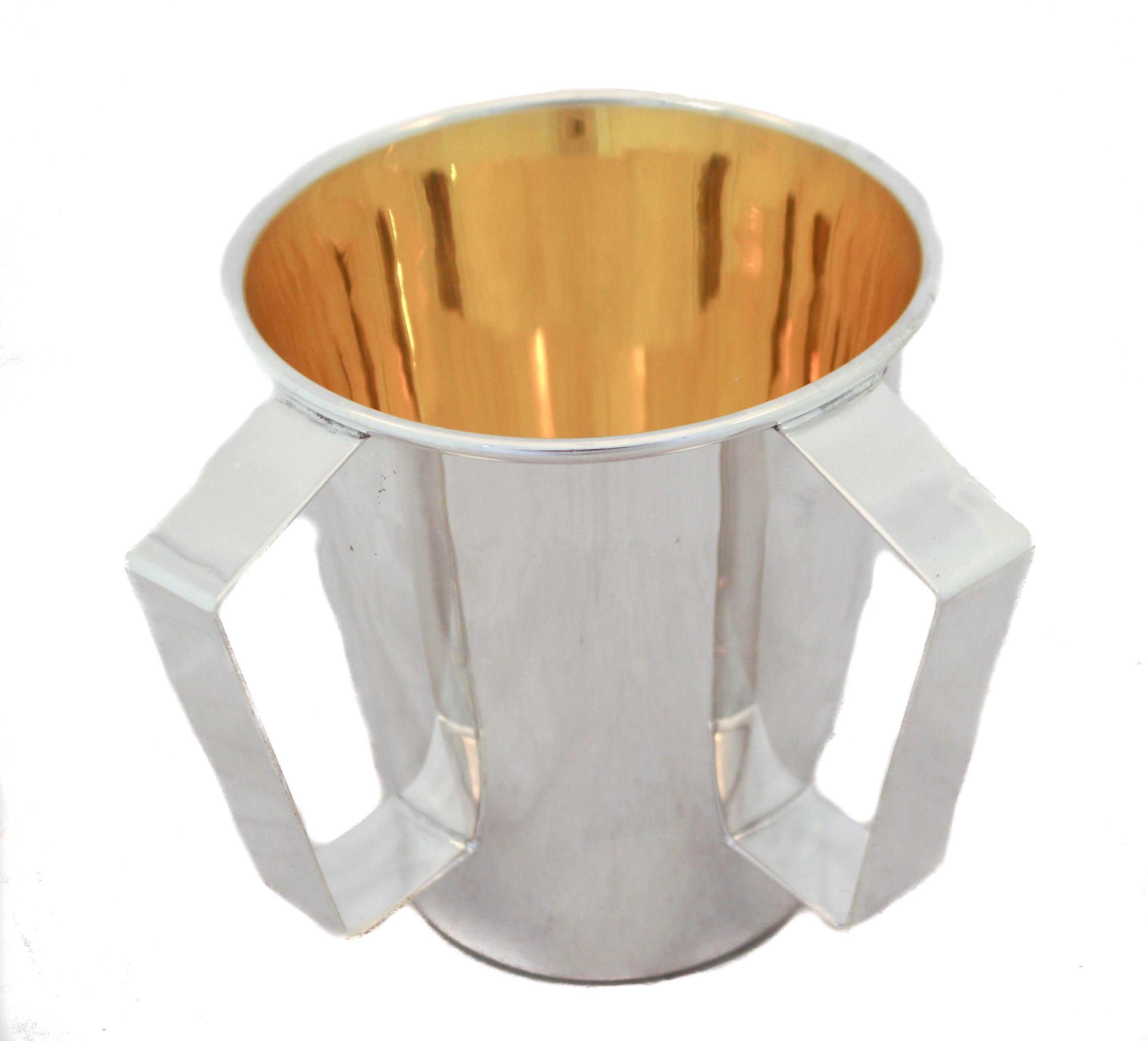 We are happy to offer you this sterling silver washing cup (n’tillat yadaiyim in Hebrew). It is used to wash the hands before eating bread and praying. This cup is uber-sleek and modern, it has that “hotel silver” look. The shape is contemporary