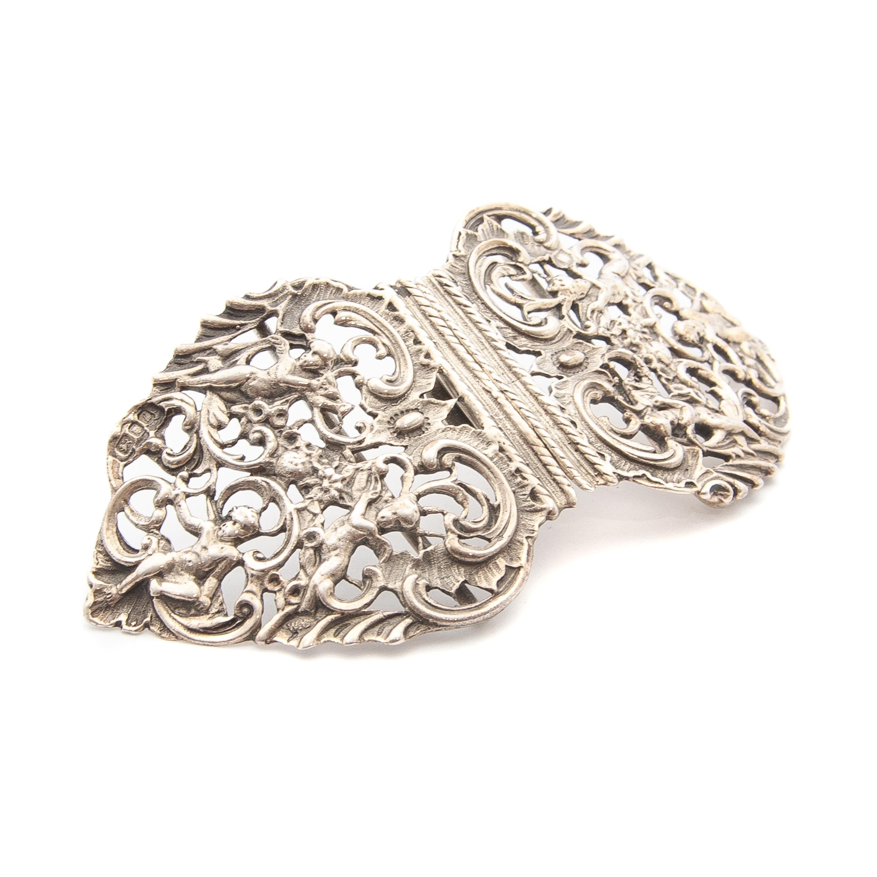 Nurses belt buckle made out of sterling silver which shows a beautiful opulent presentation. The belt buckle has a scrolling foliage openwork design, depicting with angels. The buckle is stamped with full London Hallmarks, Lion, Leopard and date