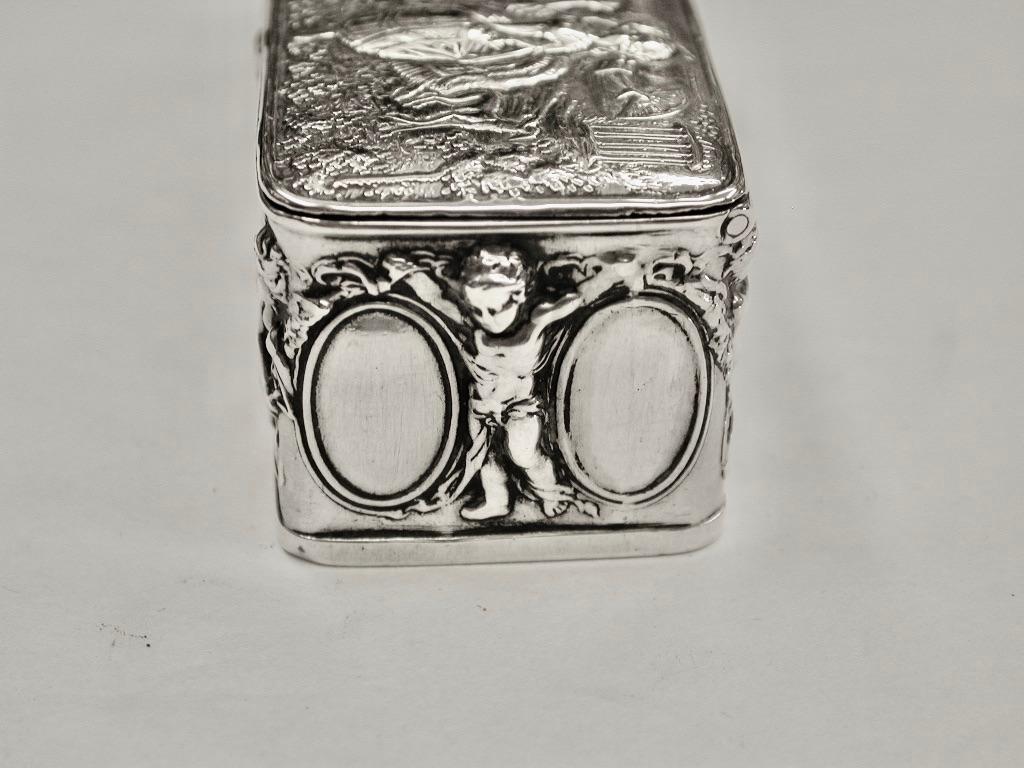 Sterling Silver Oblong Trinket Box Dated 1903 Berthold Muller 
This box has beautiful embossing with a wonderful period scene on the top  and cherubs playing all sorts of musical instruments with birds all around the sides. Berthold Muller was a