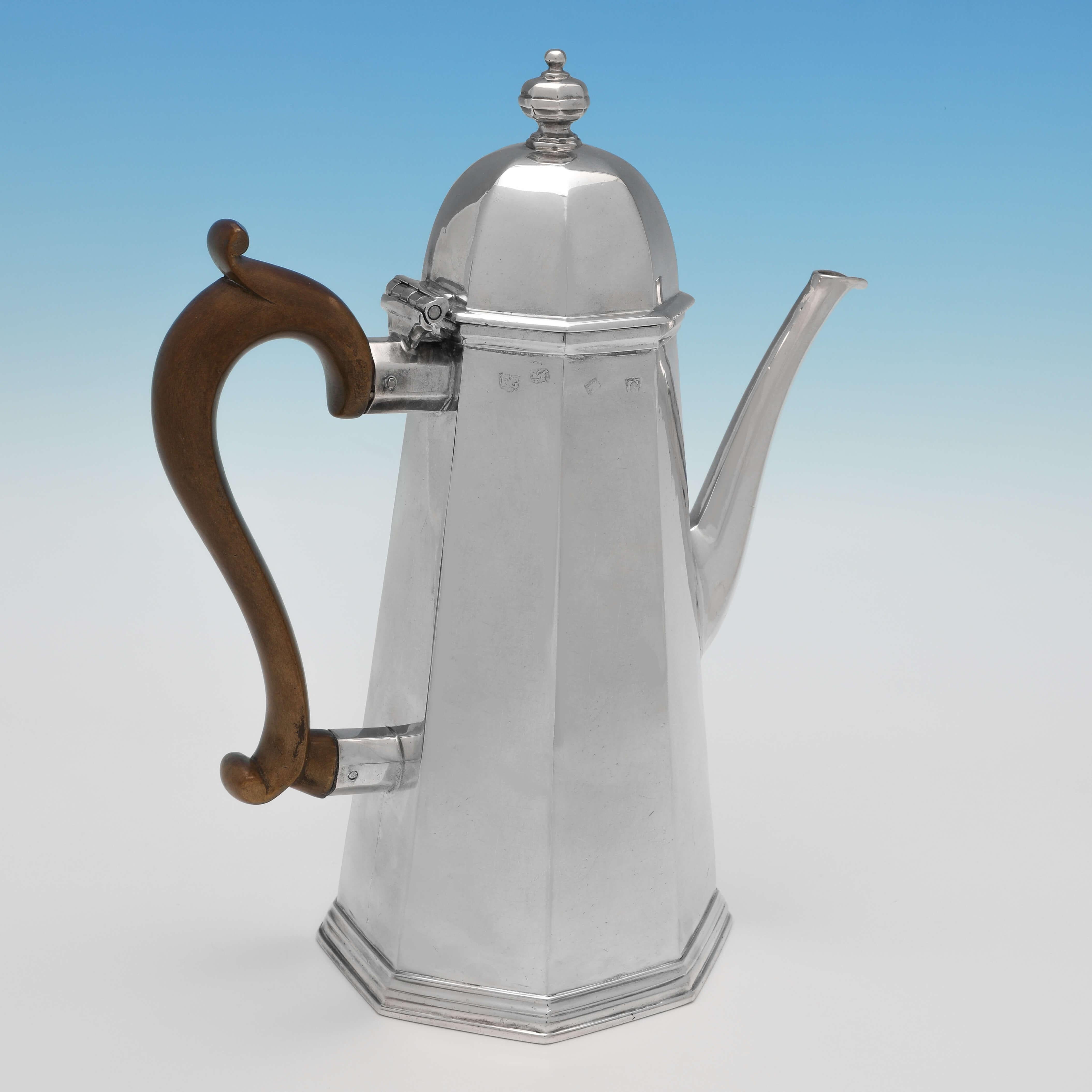 Hallmarked in London in 1722 by Francis Garthorne, this stunning, George I, Antique Sterling Silver Coffee Pot has a rare octagonal shape, with a fruitwood handle and features a full armorial engraving to one side. The coffee pot measures