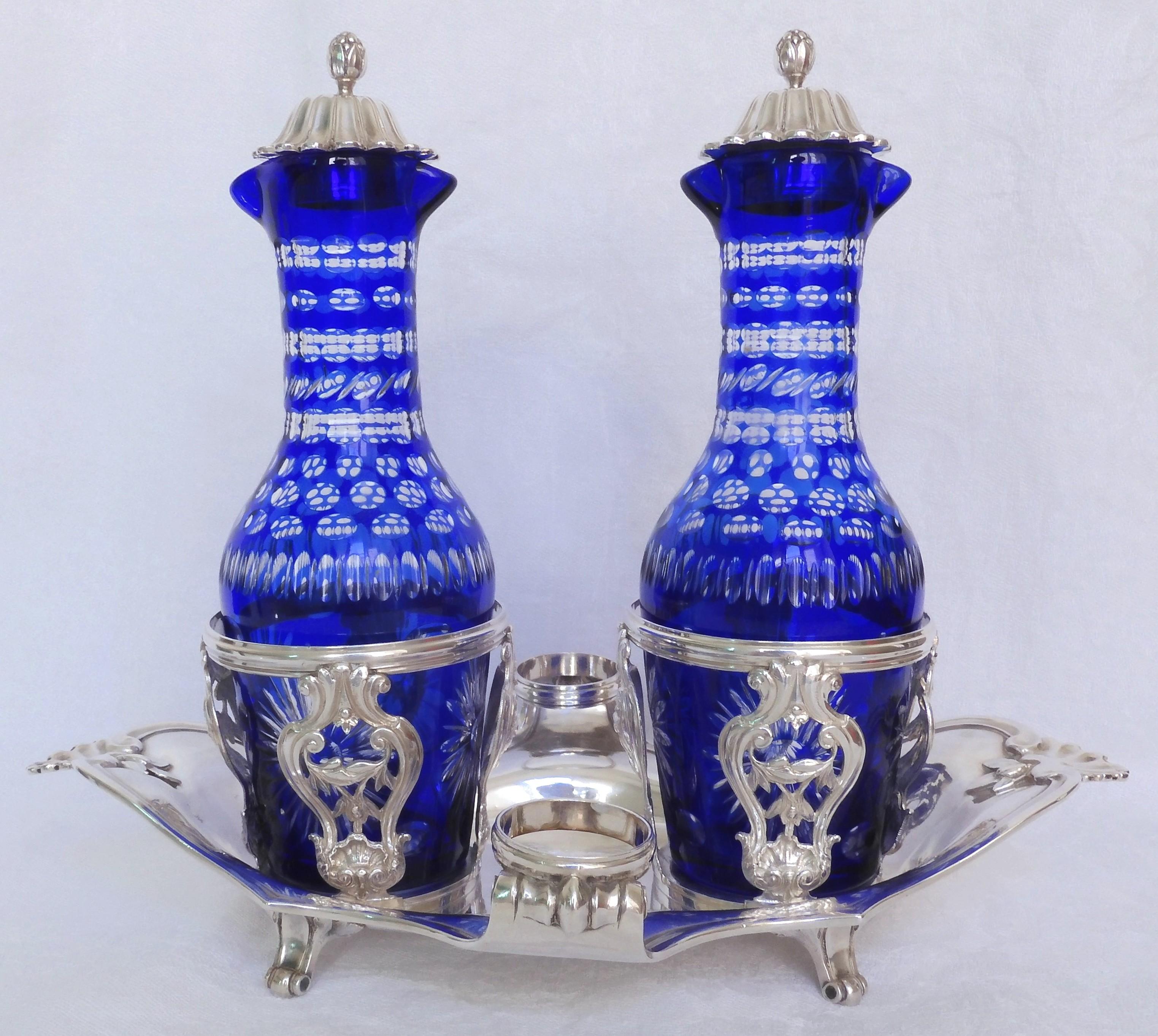 French antique sterling silver oil and vinegar set, Louis XV / Louis XVI production (18th century). Elegant shape, finely chiseled work decorated with shells and rococo patterns.

The two blue overlay crystal bottles were brought afterwards : they