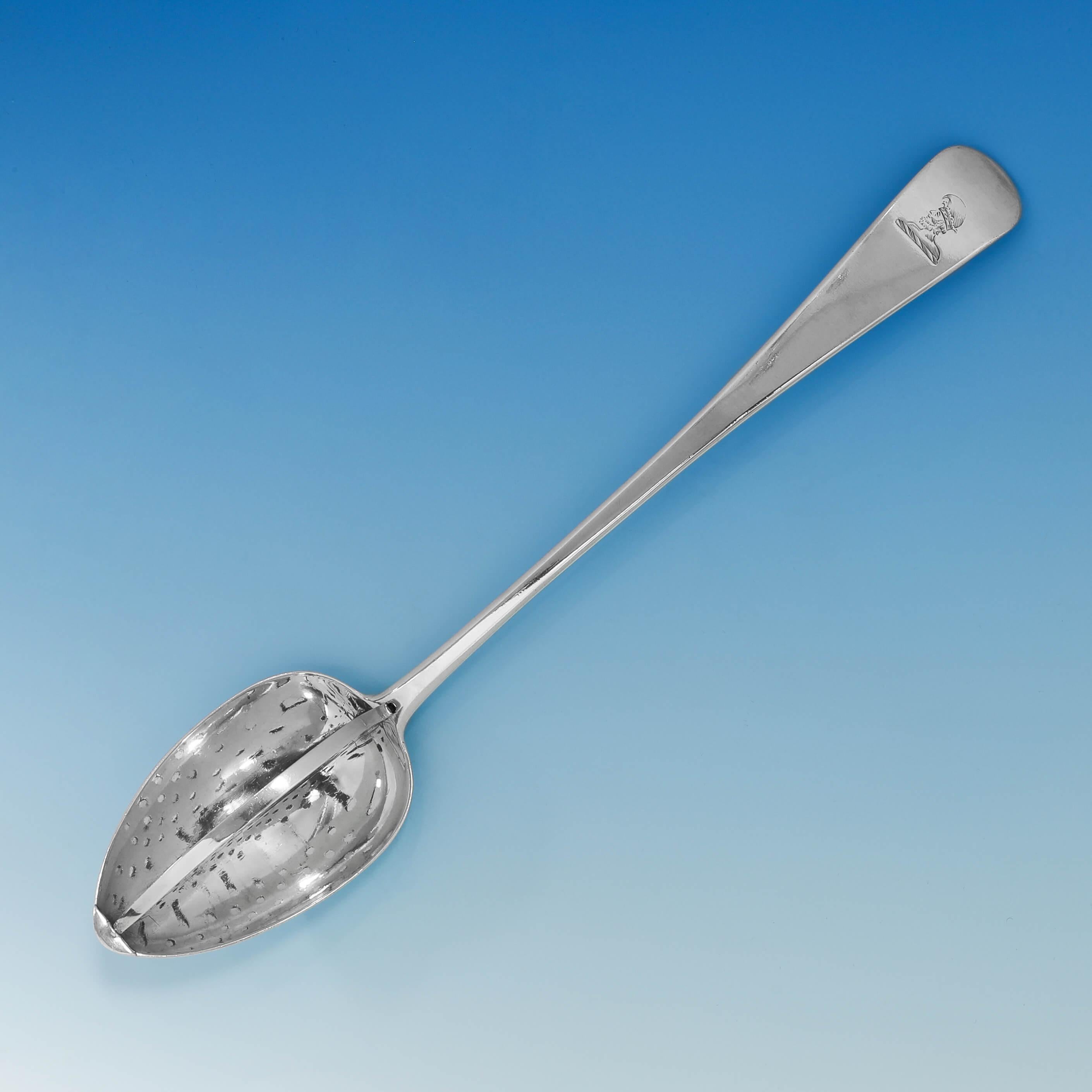 Hallmarked in Exeter in 1815 by Joseph Hicks, this handsome, antique, sterling silver straining spoon, is in the 'Old English' pattern and features a strainer to the bowl which can be removed for cleaning, and an engraved crest. The straining spoon