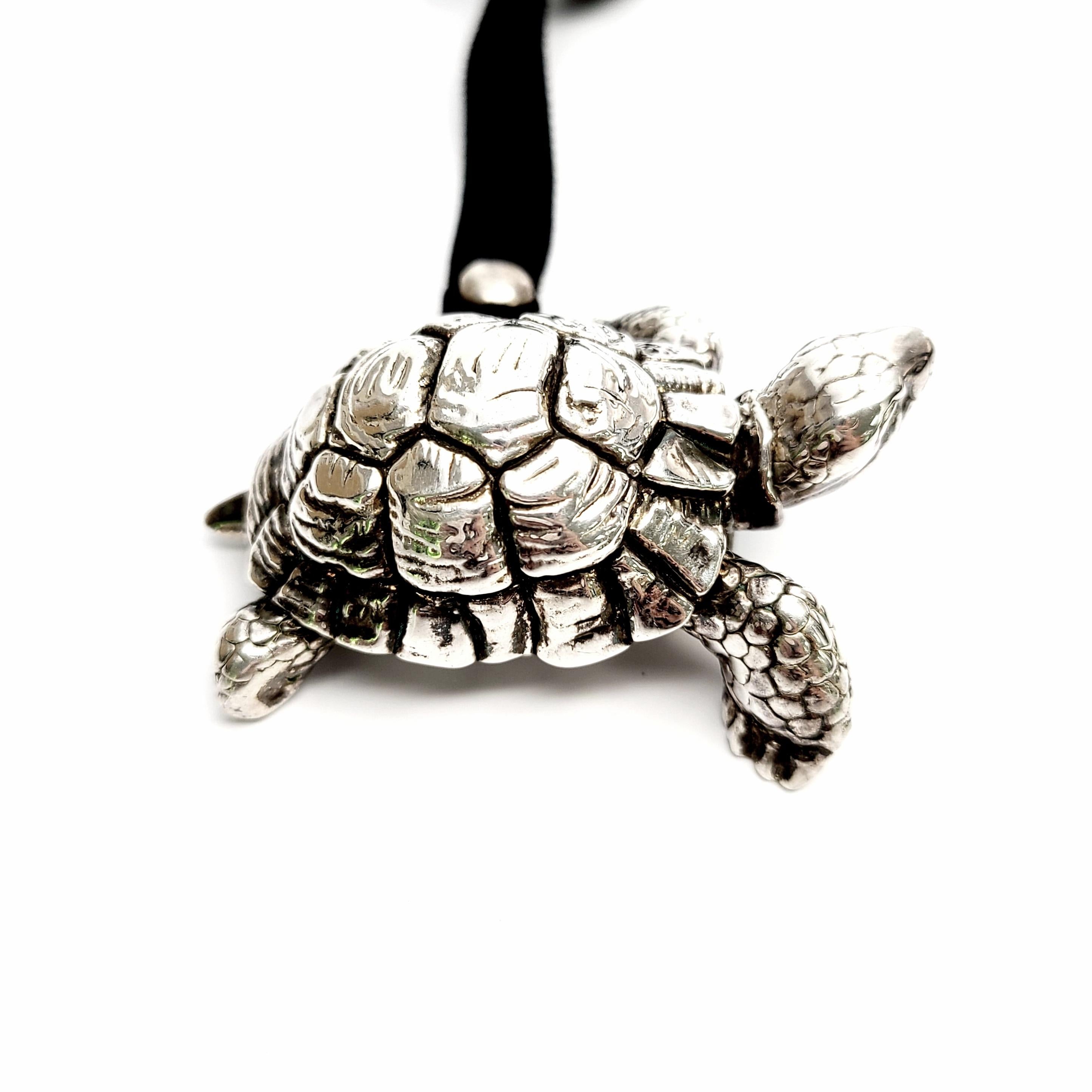 Vintage sterling silver on wax turtle charm on a velvet tie.

Beautifully detailed large but lightweight turtle on velvet tie with silver woven design endcaps.

Turtle measures approx 2 1/4