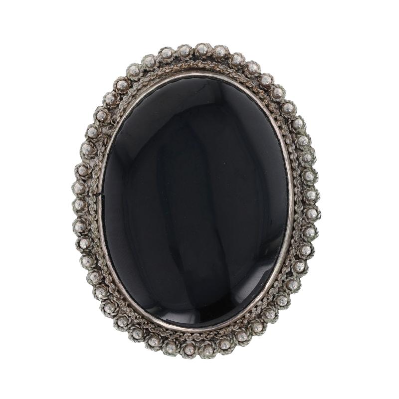Metal Content: Sterling Silver

Stone Information

Natural Onyx
Cut: Oval Cabochon
Color: Black

Style: Solitaire Brooch
Fastening Type: Hinged Pin and Whale Tail Bullet Clasp
Features: East-West Set Solitaire with Bead & Rope-Textured