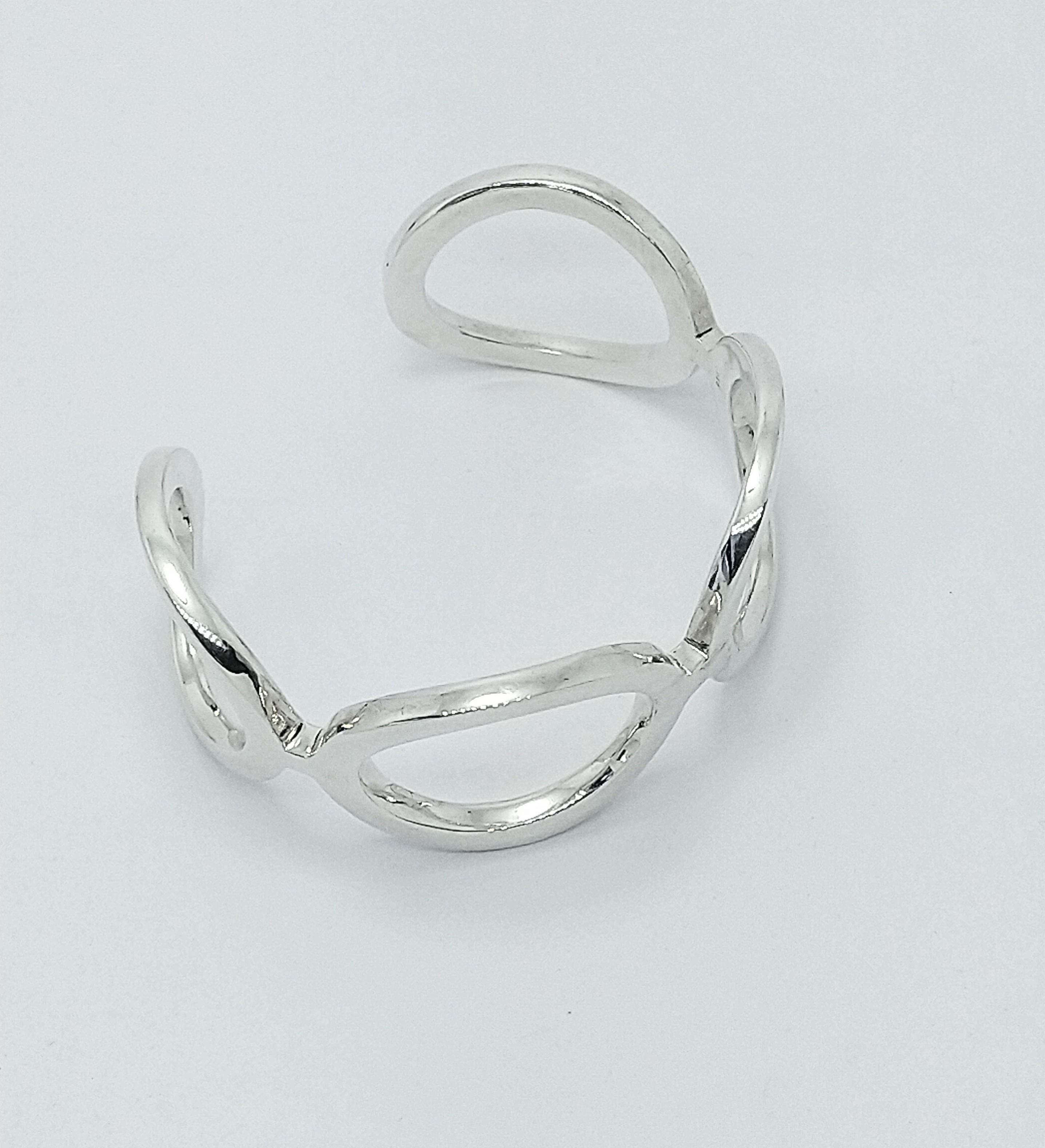 Sterling Silver Oval Cuff Bracelet , 4 x 3 mm thick x 29 mm wide. This is one of my early designs.  I was using simple shapes for the ultimate in expression of sculpture and a piece of jewelry. One of the 3 cuff bracelets geometric collection I