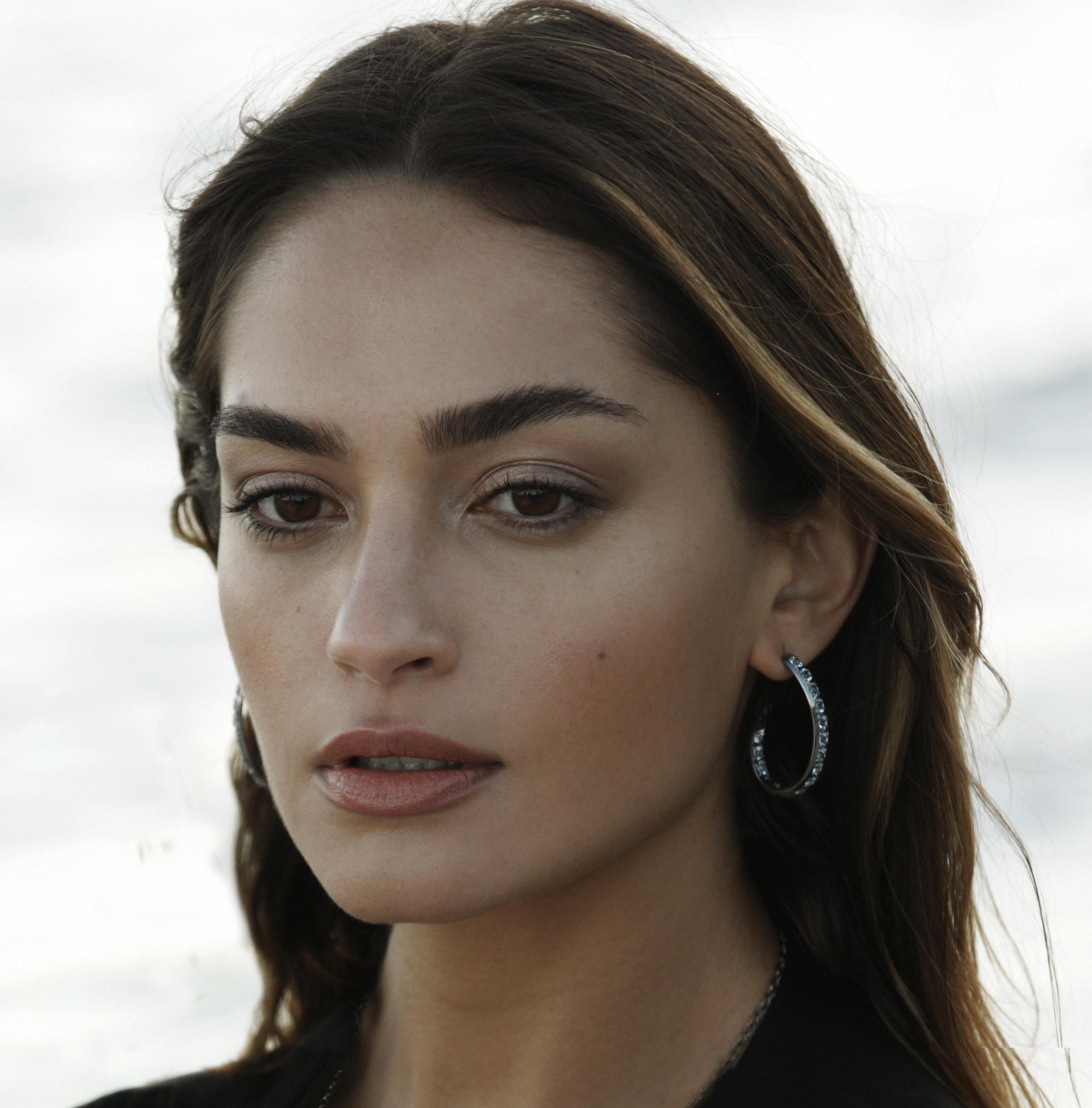Edgy, lightweight bands of light, the Flamingo hoop earrings in sterling silver and white topaz add effortless dress-up to a casual look, boosting poignant originality and flair by day and by night.
The artist's logo is creatively finessed into the