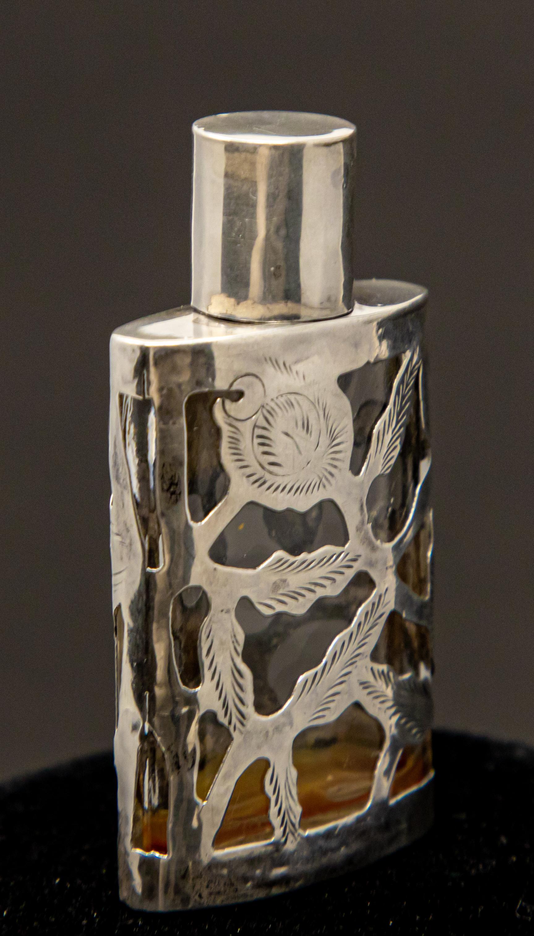 Offering this gorgeous Art Nouveau sterling silver over glass perfume bottle. It is smaller scale but the intricate detail make this a stand out to others.