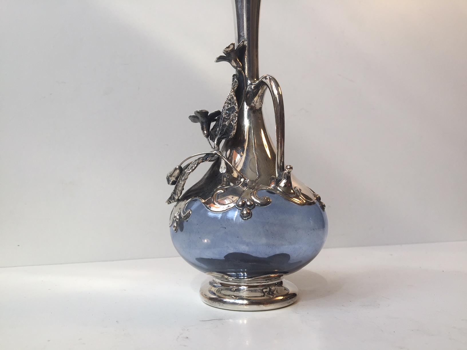 Decorative and ornamental flower vase made of blue glass that has been caged/overlayed with silver. It is made by Culag and is imprinted 925 to the base. Fine intact condition un-polished.