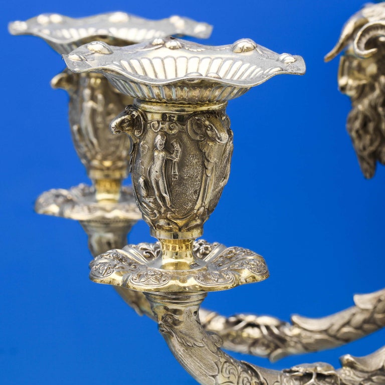 Hallmarked in London in 1875 by Alexander Macrae, this sensational pair of Victorian Antique, sterling silver candelabra bear the crest of William Duncombe, 1st Earl of Feversham, and feature wonderful ornate decoration throughout. Each candelabrum