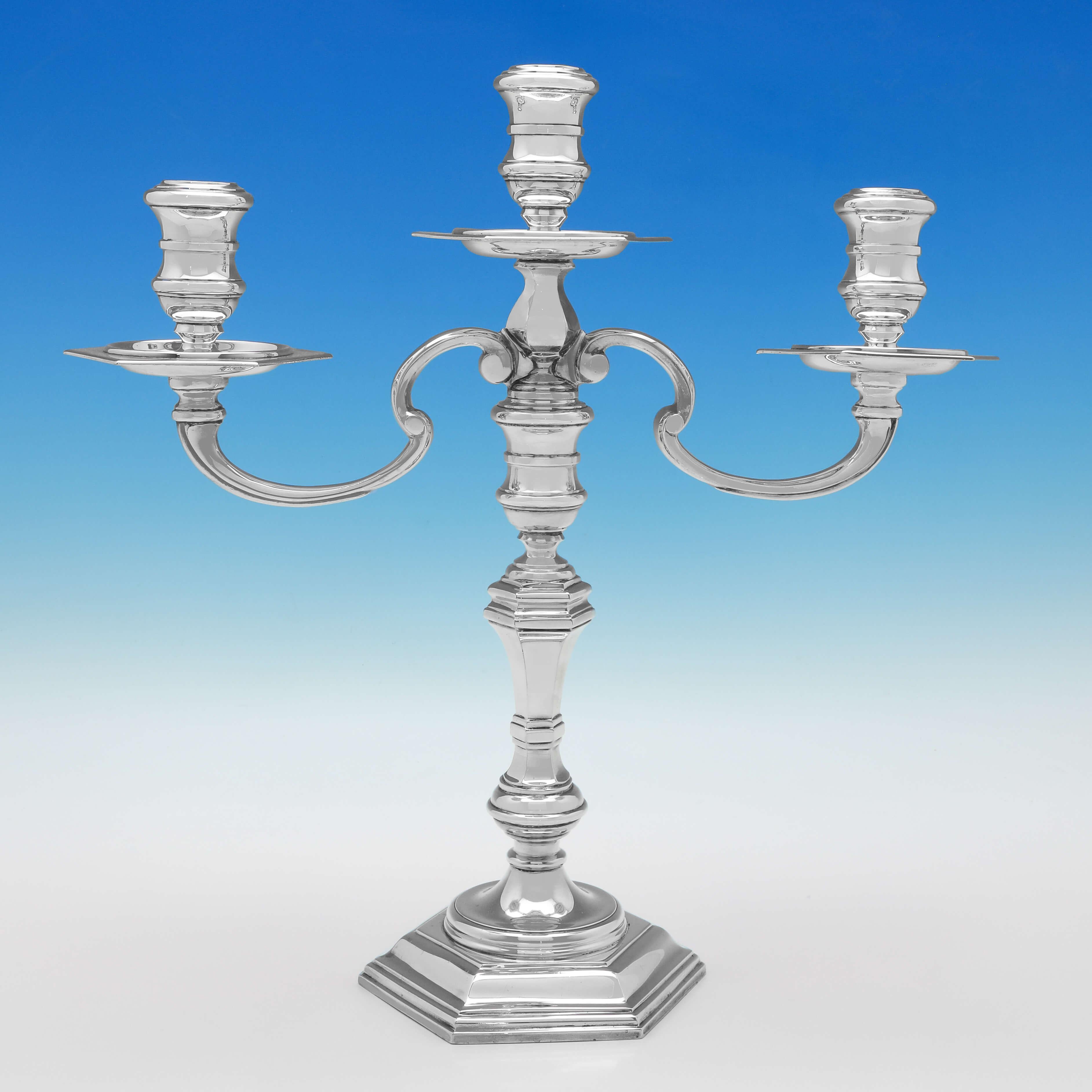 Hallmarked in London in 1962 by Richard Woodman Burbridge, this handsome pair of Sterling Silver Candelabra, are cast and hexagonal in shape, with removable branches. Each candelabrum measures 15.25