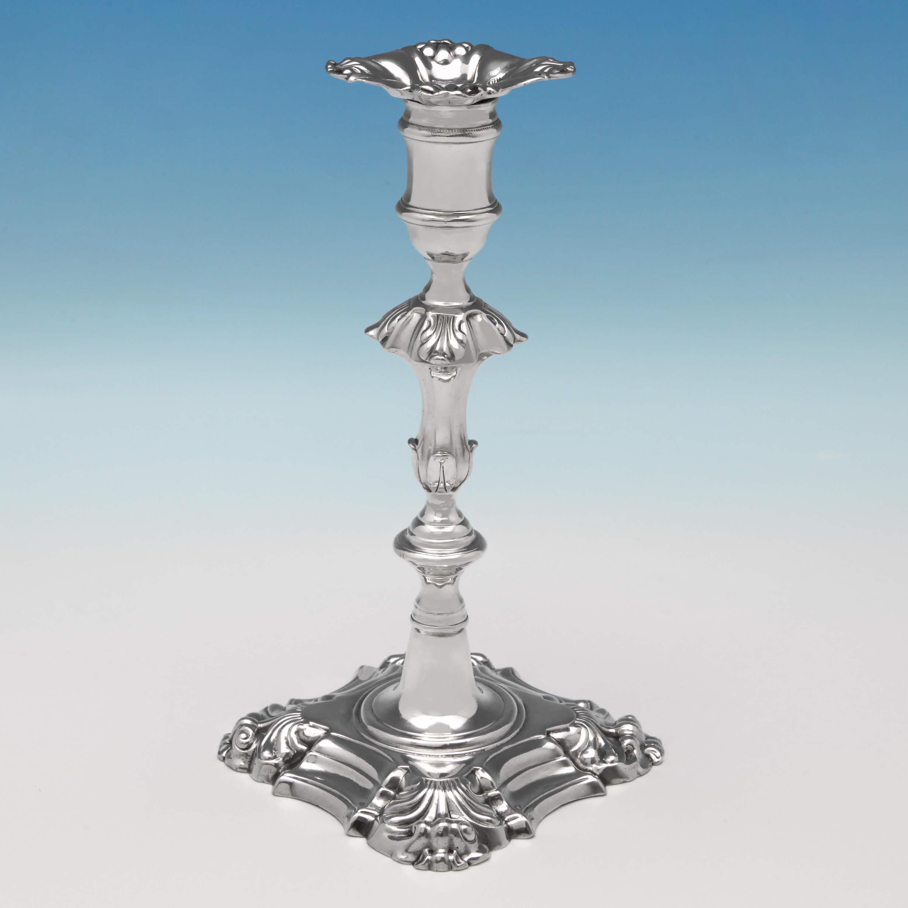 Hallmarked in London in 1870 by Frederick Brasted, this heavy, cast pair of antique, Victorian, sterling silver candlesticks are in the George II 