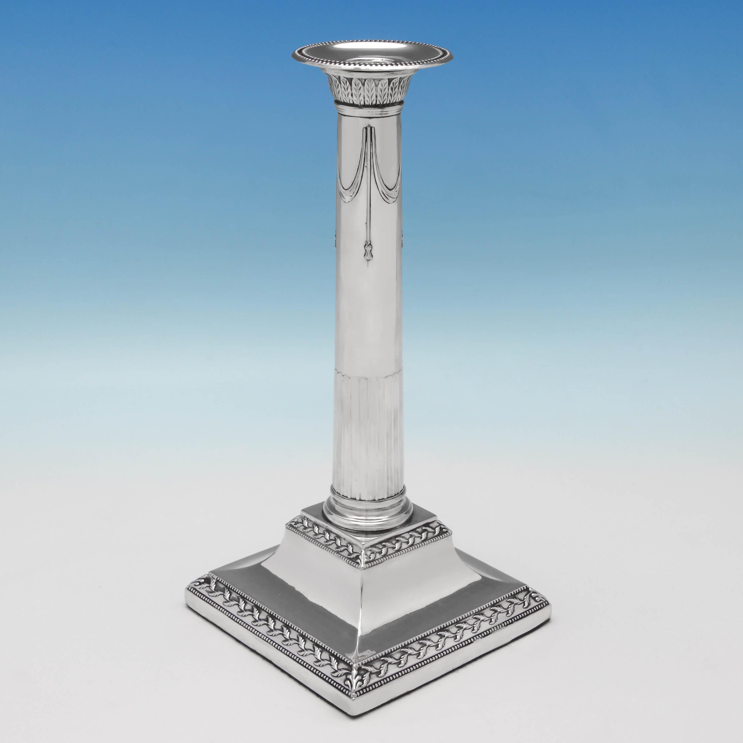 Hallmarked in Sheffield in 1790 by J. Parsons & Co., this handsome, George III, antique, sterling silver pair of candlesticks, feature acanthus decoration to the capitals, bead and fern borders to the bases, sunken fluting and ribbon work to the
