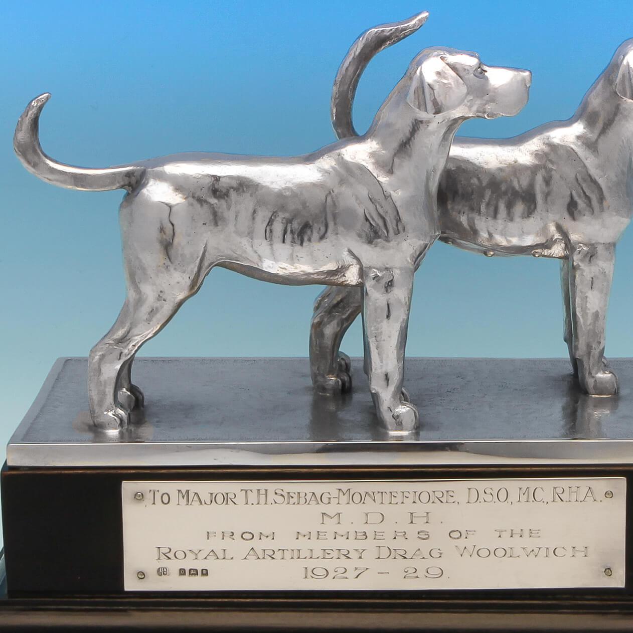 Hallmarked in London in 1929 by Blackmore & Fletcher Ltd. This handsome pair of sterling silver hound dogs stand proudly on a wooden plinth, and comprise a female and male dog, which is rare to see. The plinth bears an engraved plaque which reads: