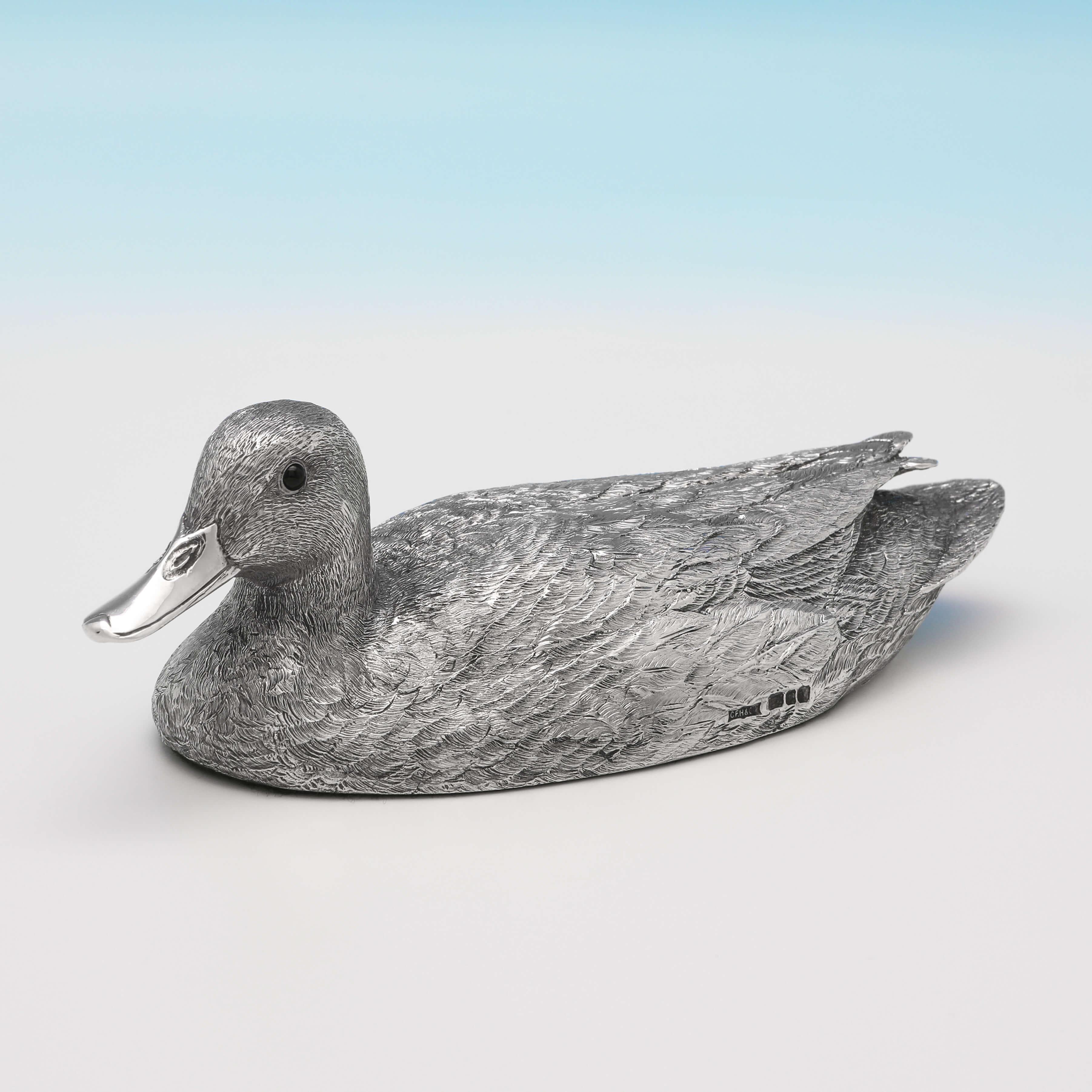 Hallmarked in London in 1989 by Hancocks & Co., this wonderfully modelled pair of Elizabeth II, sterling silver mallard ducks, are very realistically cast, with fine feather detailing and brown bead eyes. Each duck bears an engraved signature for