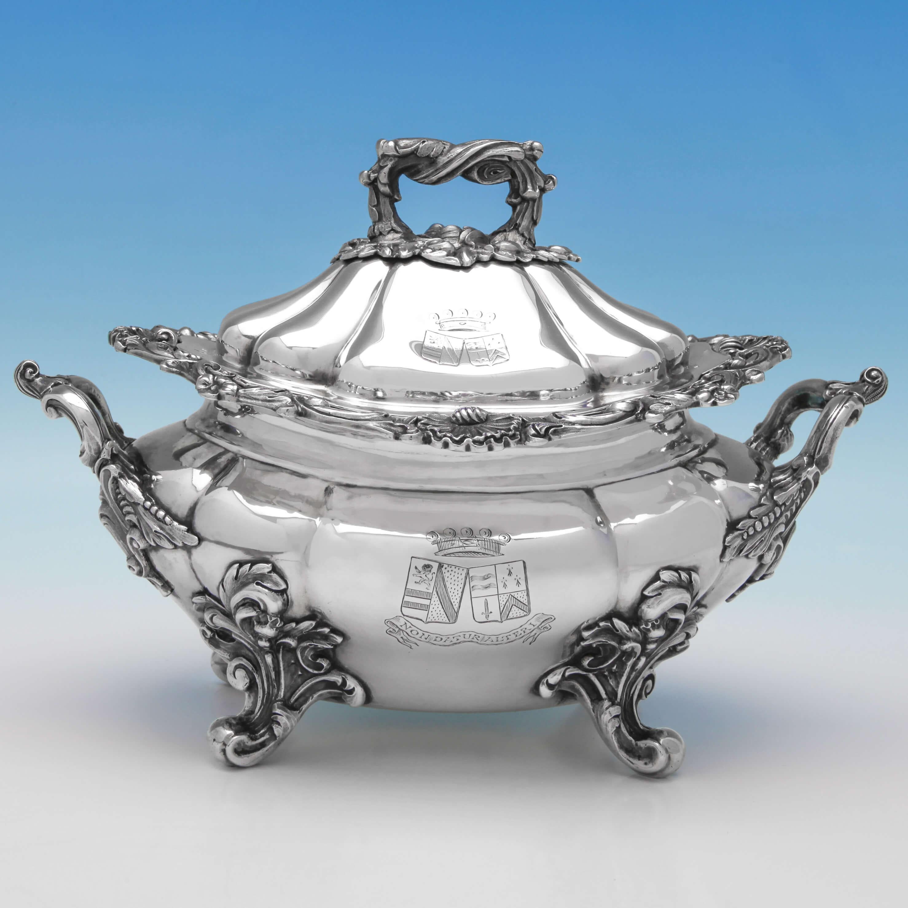 Hallmarked in London in 1842 by John Figg, this extraordinary pair of Victorian, antique sterling silver Sauce Tureens, feature scroll borders, ornate handles and feet, and engraved crests and mottos. Each sauce tureen measures 7