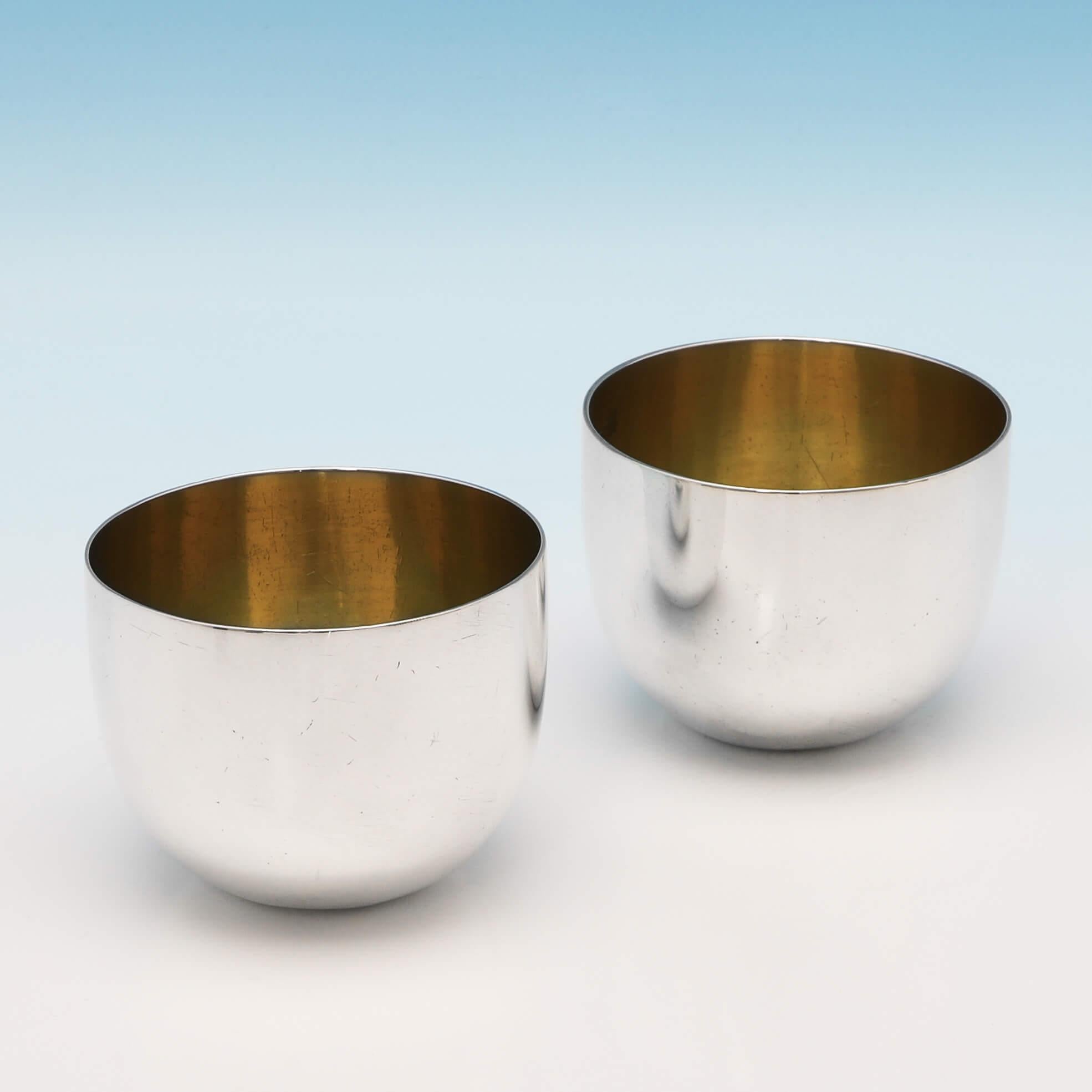 Hallmarked in London in 1793 by Richard Evans, this handsome, pair of George III, antique sterling silver tumbler cups, are plain in style, with gilt interiors. Each tumbler cup measures: 2