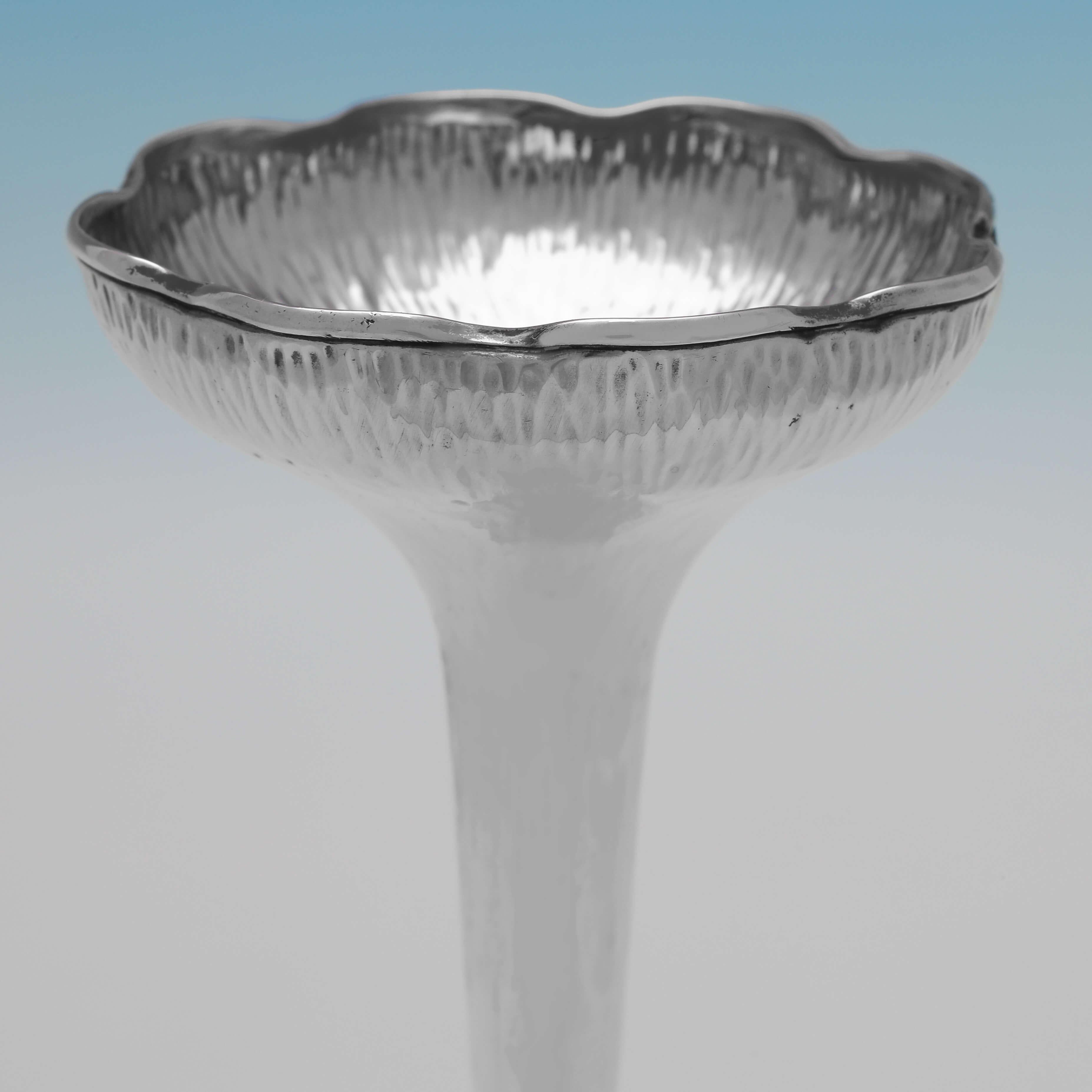 Hallmarked in Birmingham in 1904 by Henry Matthews, this attractive Edwardian, Antique Sterling Silver Vase, features a planished finish. It measures 6.75