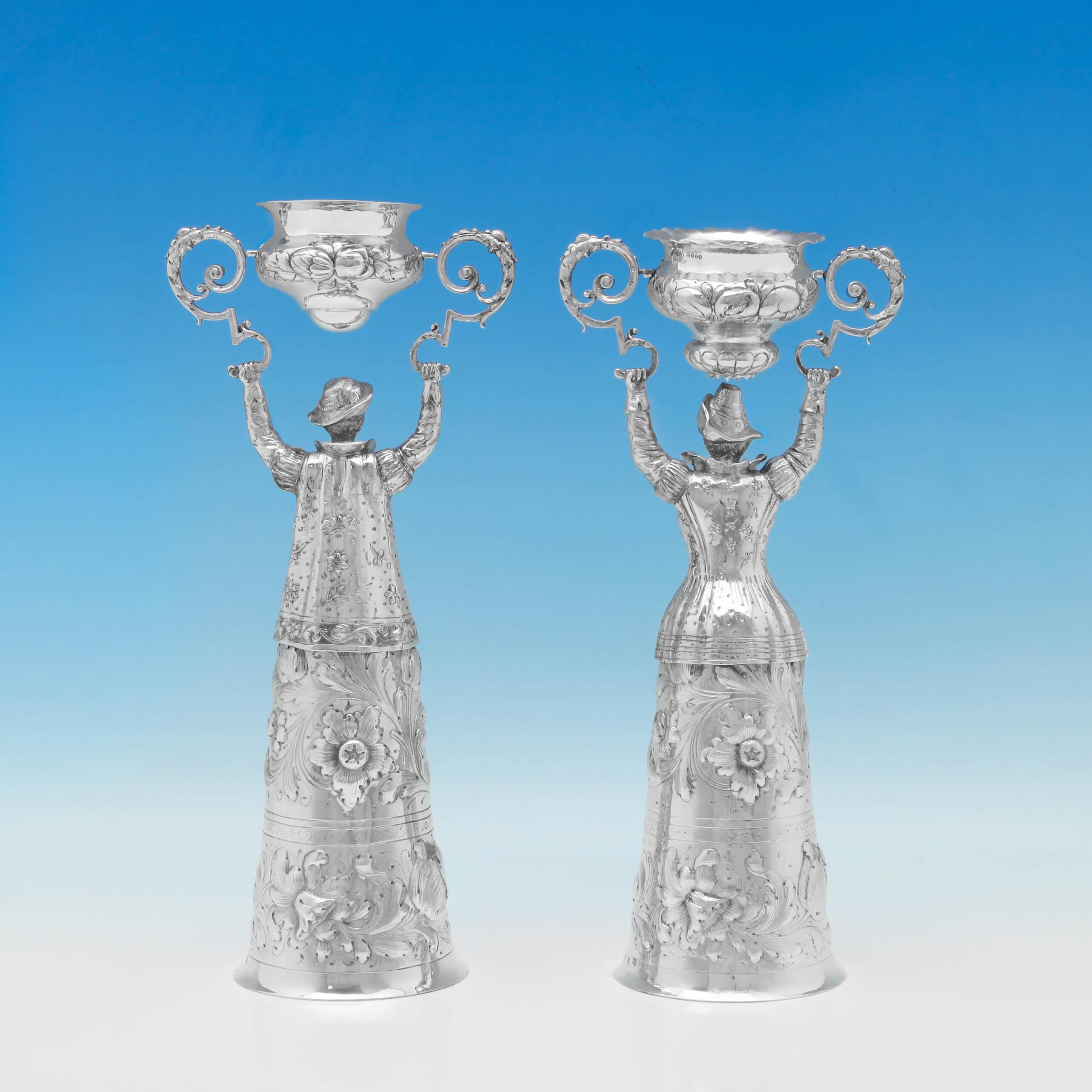 Carrying import marks for London in 1897 by William Moering, this fine Pair of Victorian, Antique, Sterling Silver Wager Cups, take the form of a man and a woman in costumes, with chased decoration throughout. Each wager cup measures 12.25