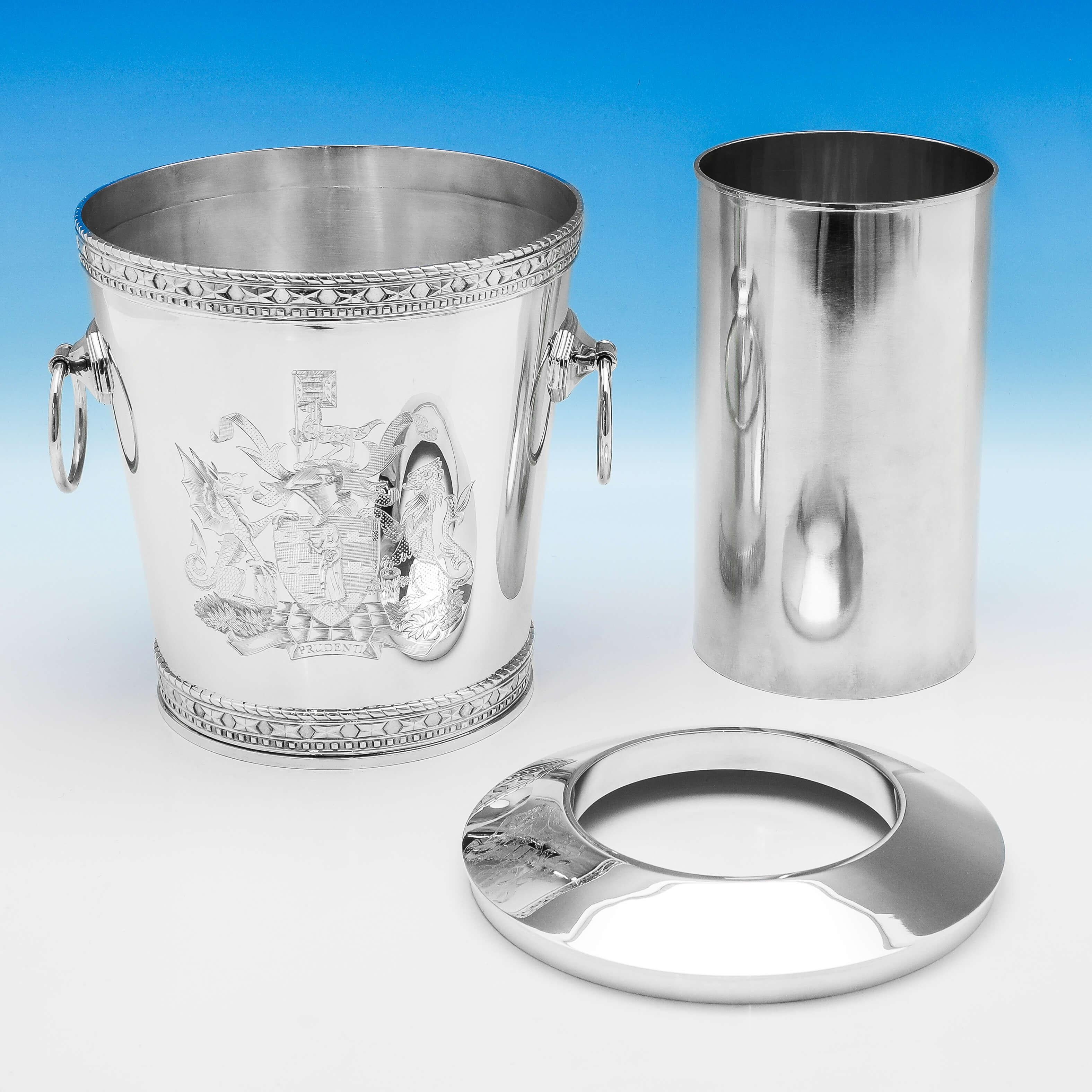 Hallmarked in London in 1995 by I. Franks, this spectacular pair of Elizabeth II, Sterling Silver Wine Coolers, are hand engraved with the Coat of Arms for Prudential Insurance Company, who commissioned these directly from us. Each wine cooler