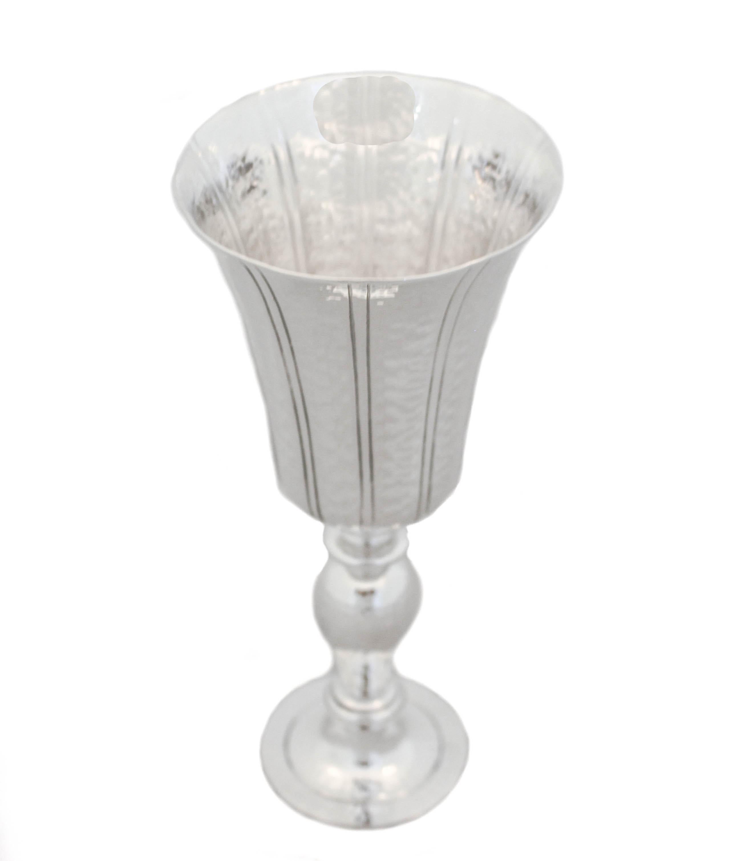 We are thrilled to offer you this sterling silver goblet by Pampaloni. It is hand-hammered and has a beautiful shape. The top of the cup curves outward giving it a regal presence. A very special piece that will look gorgeous in any decor.