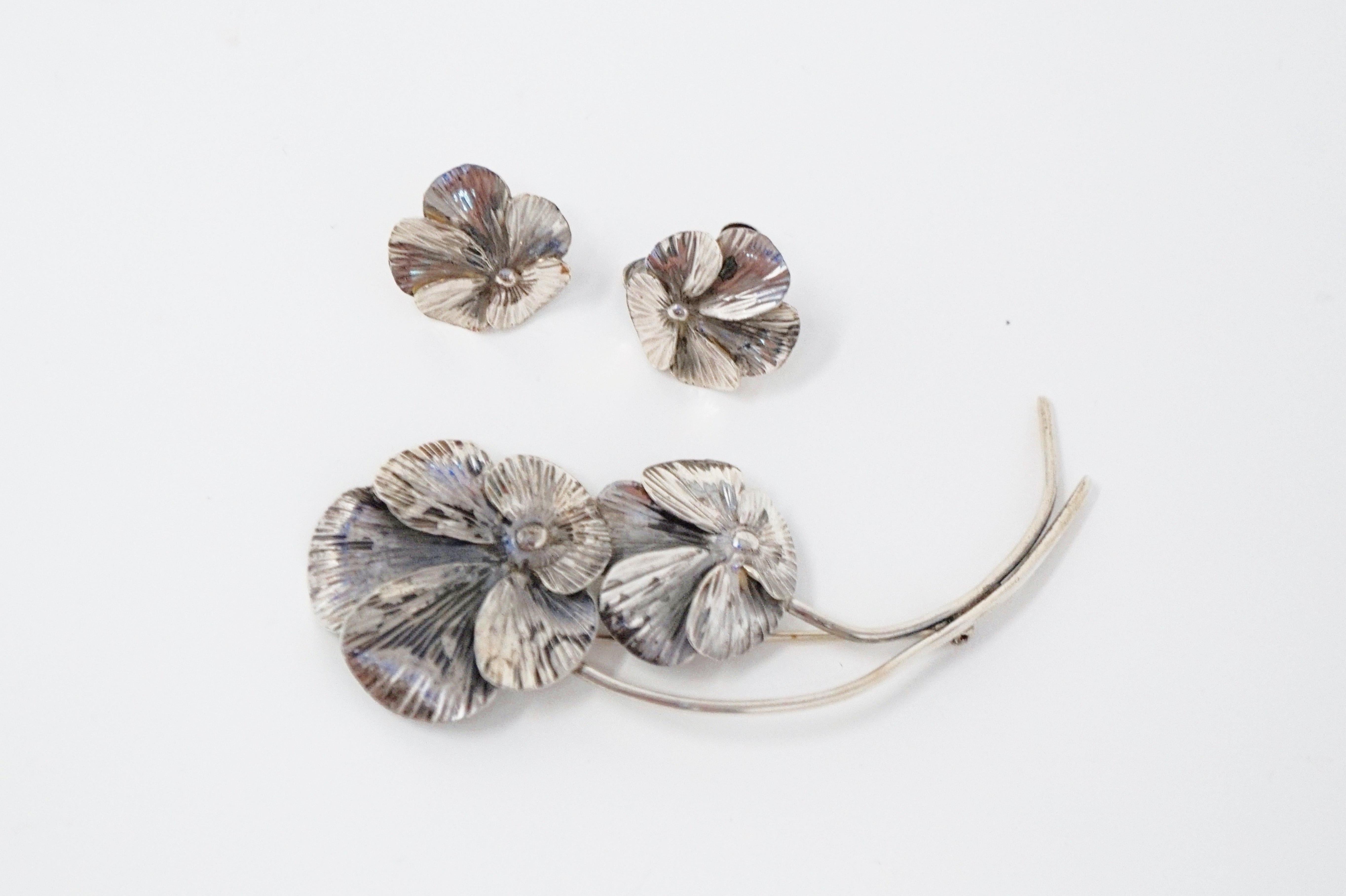 This beautiful sterling silver Pansy flower demi-parure brooch and clip-on earring set was handmade by artisan Stuart Nye, circa 1940s.  This particular pansy design was patented by Stuart Nye on September 17, 1940 (see photos) and that patent