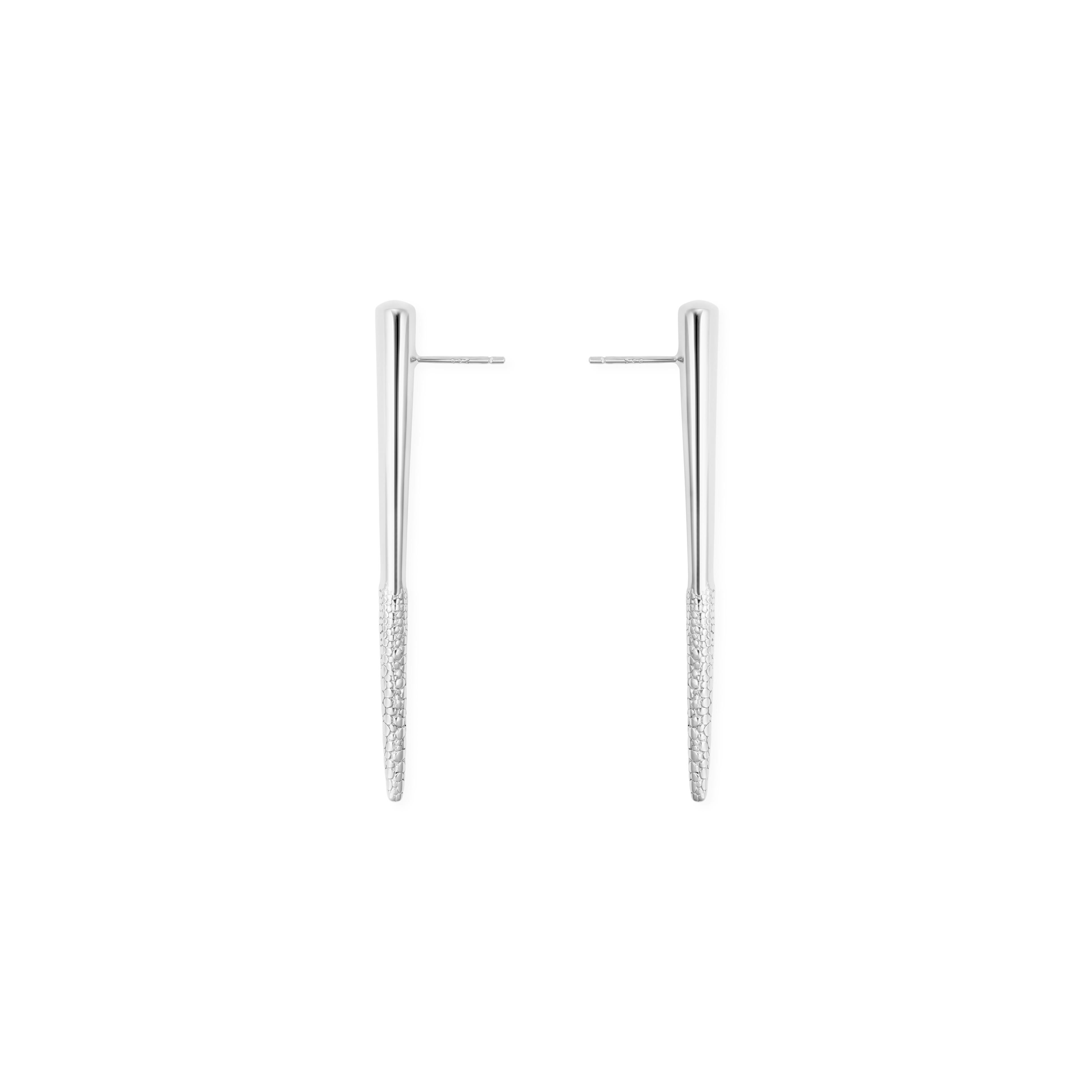 The Particle Earrings, by Mistova, are from the NOVA 01 collection.The earrings are made from sterling silver and have a strong and fluid design. The bottom has a textured surface treatment to add contrast to these earrings.  Highly polished surface