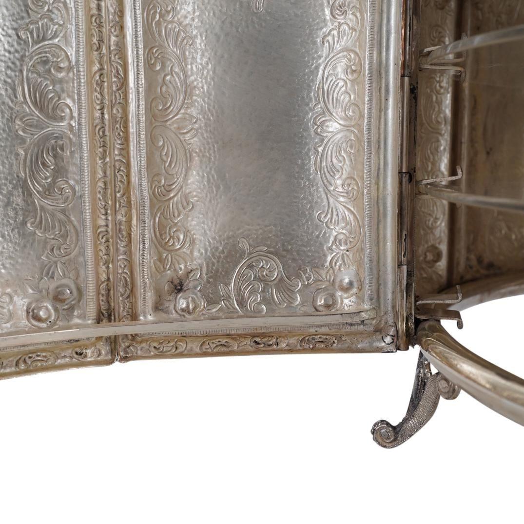Finely crafted sterling silver Passover seder tray and chest measuring 14 inches across with two acrylic shelves with beautiful chased and repousse designs throughout and raised on four scrolling feet.  Silver weight: 2,176 grams. 