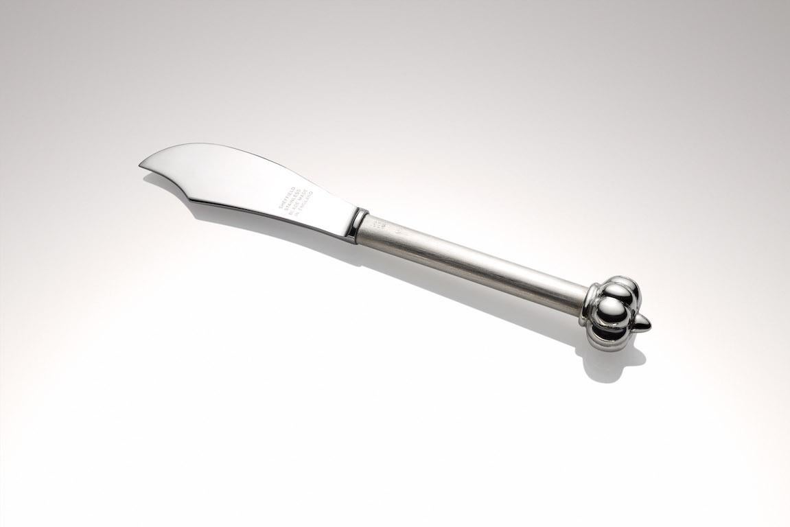 .925 Sterling Silver Pate Knife is made with durable Sheffield stainless steel blade.  The sterling silver pumpkin finial is custom cast from a carved wax.  
The handle is filled heavy gage sterling tubing.
This delightful dainty pate knife will