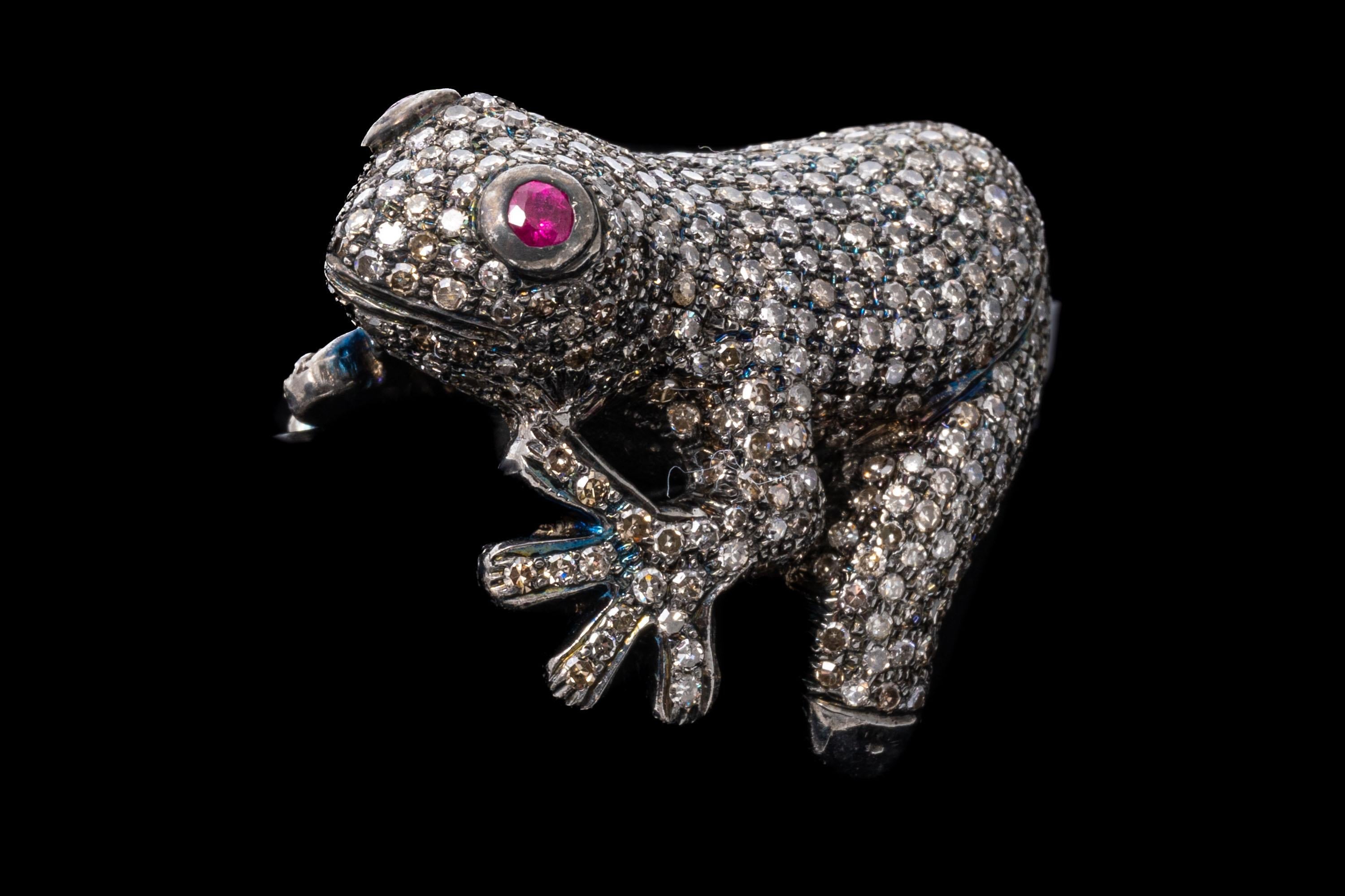 Sterling silver ring. This spectacular ring is a figural frog, set in the entirety with pave set, round faceted diamonds, approximately 2.63 TCW, with the exception of the ring shank, which remains high polished. Round faceted pinkish red color