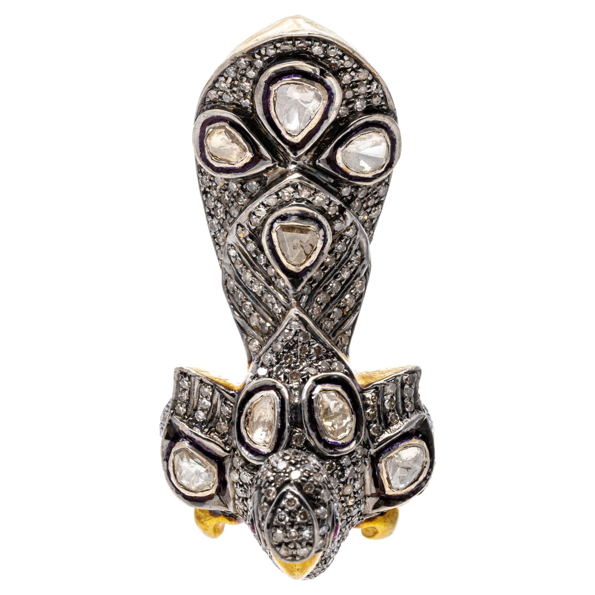 Sterling silver ring. This magnificent ring is a figural peacock, set in the entirety with pave set, round faceted diamonds and studded with bezel set, macle cut diamonds in between. Highlighting the beak and feet is a high polished vermeil finish