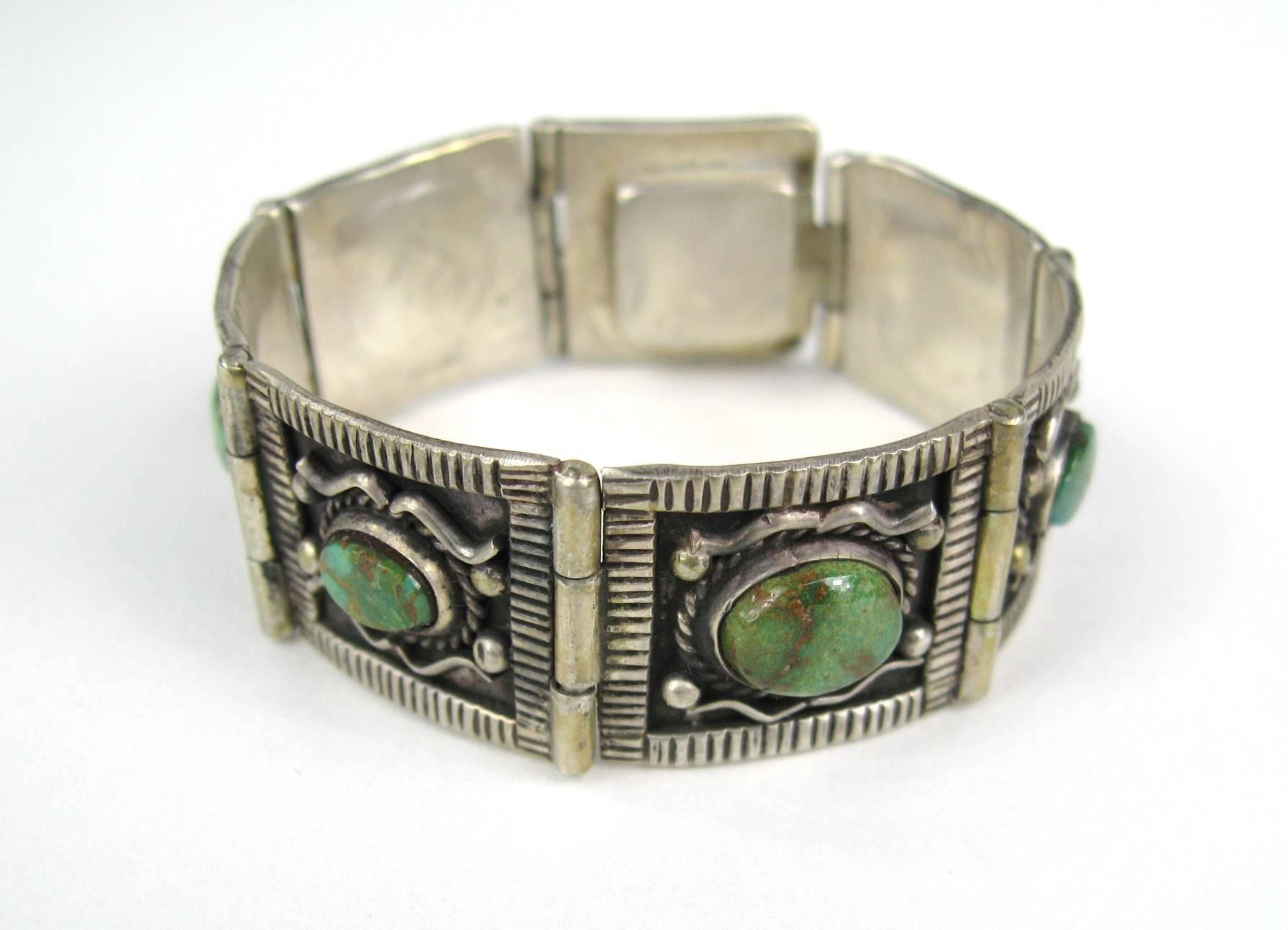 Fabulous  sterling silver paneled bracelet with a slide in clasp. Measuring .81 in wide - 7.5 inches end to end. 7 Panels each with a bezel set Turquoise stone. Will fit a 6