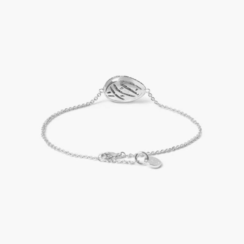 Sterling silver Pebble white diamond bracelet with black diamonds

This bracelet is formed in an irregular pebble shape and covered in a pave of white and black diamonds. This sterling silver design features a crossover pattern laid out in the