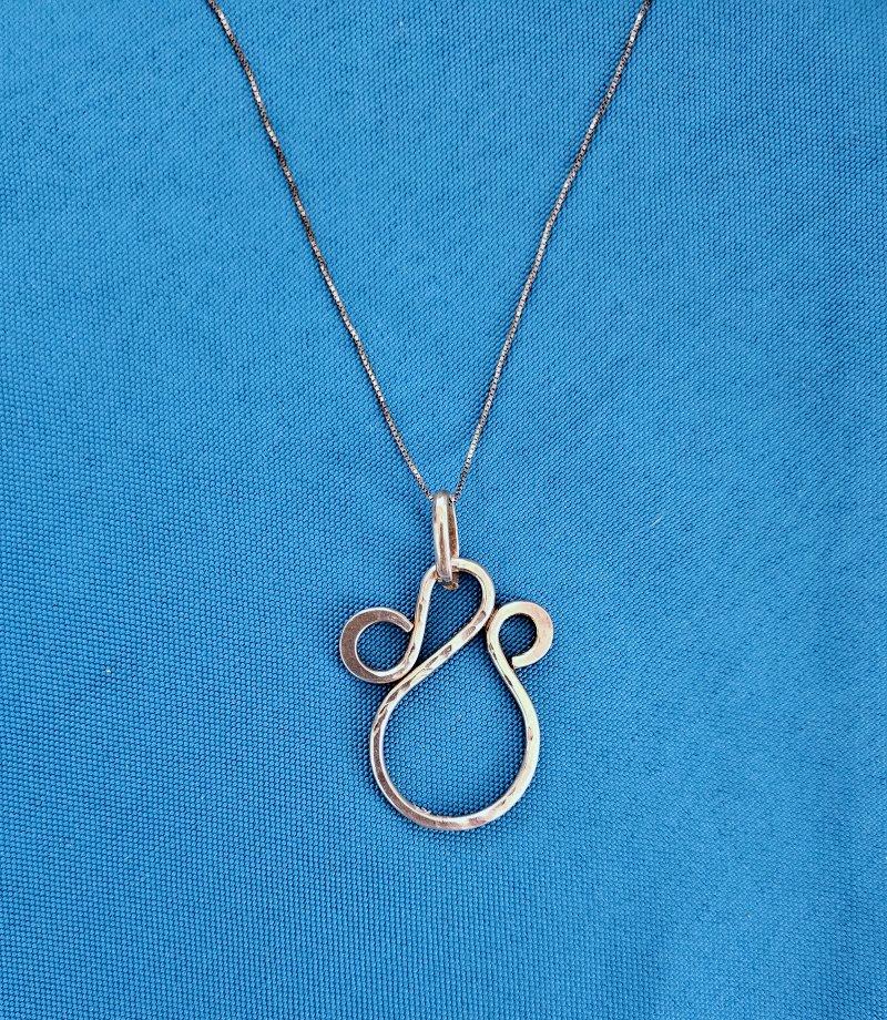 Sterling Silver Pendant Necklace, Hammered Texture on Front, Stamped on Back
This is a unique pendant necklace with a handsome hammered silver front texture. The chain and the pendant are stamped. 
Needs cleaning, especially the chain.
IMPORTANT