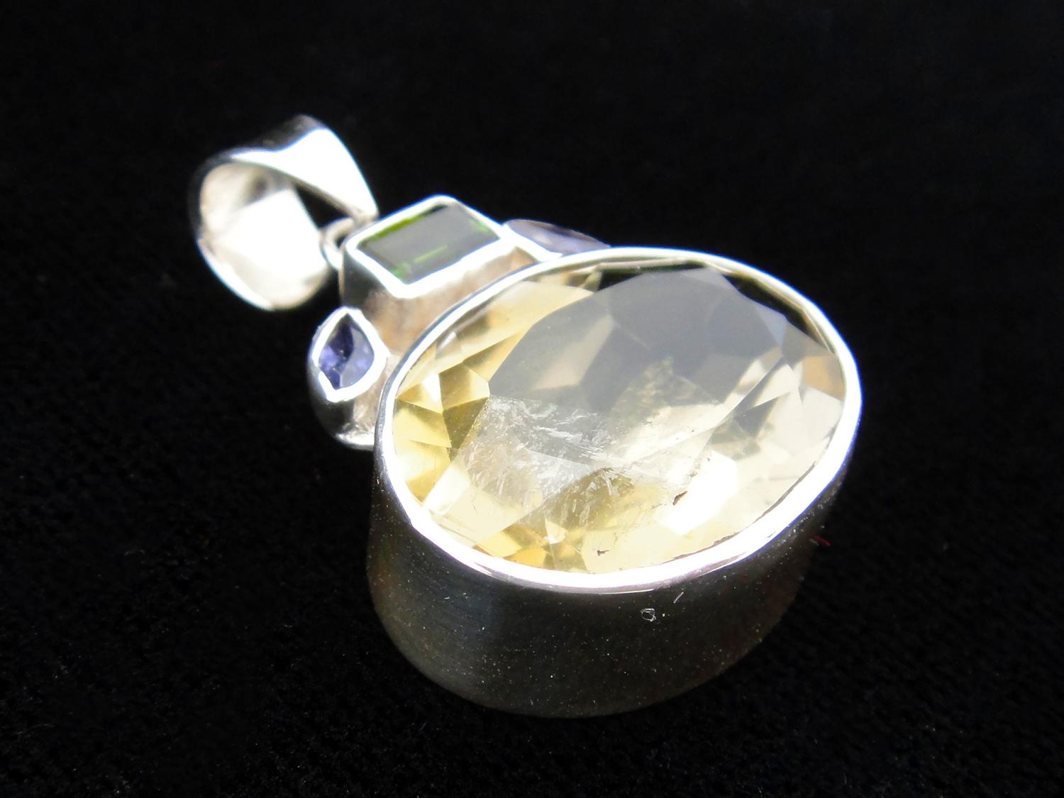 We collaborate with a master silversmith in Kotegeti, Java, the heart of the silver industry in Indonesia to create these one of kind peices. This sterling silver pendant features a faceted lemon quartz cabochon and is highlighted by tourmaline and