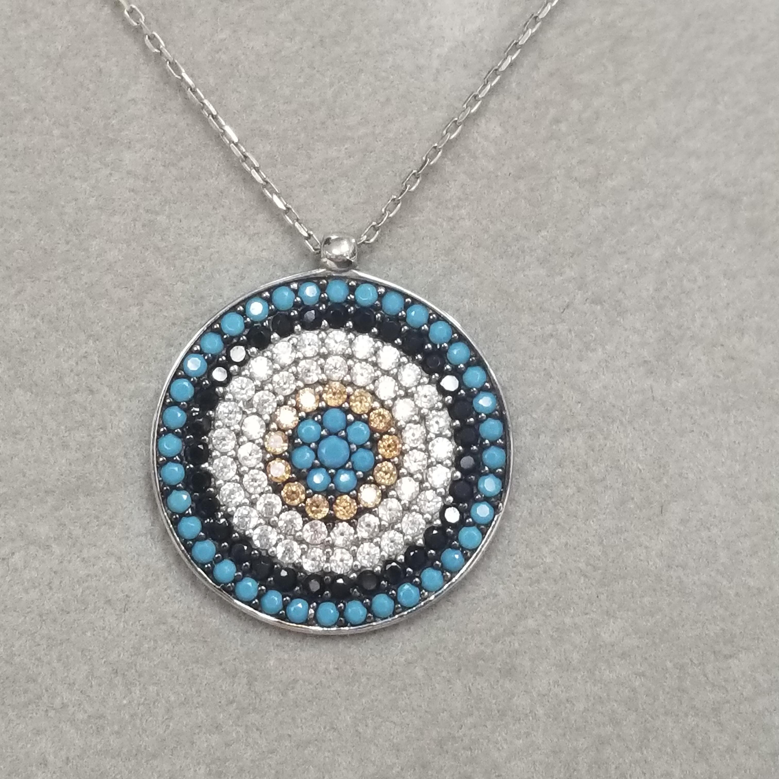Sterling Silver pendant with turquoise and cubic on an 18 inch chain.