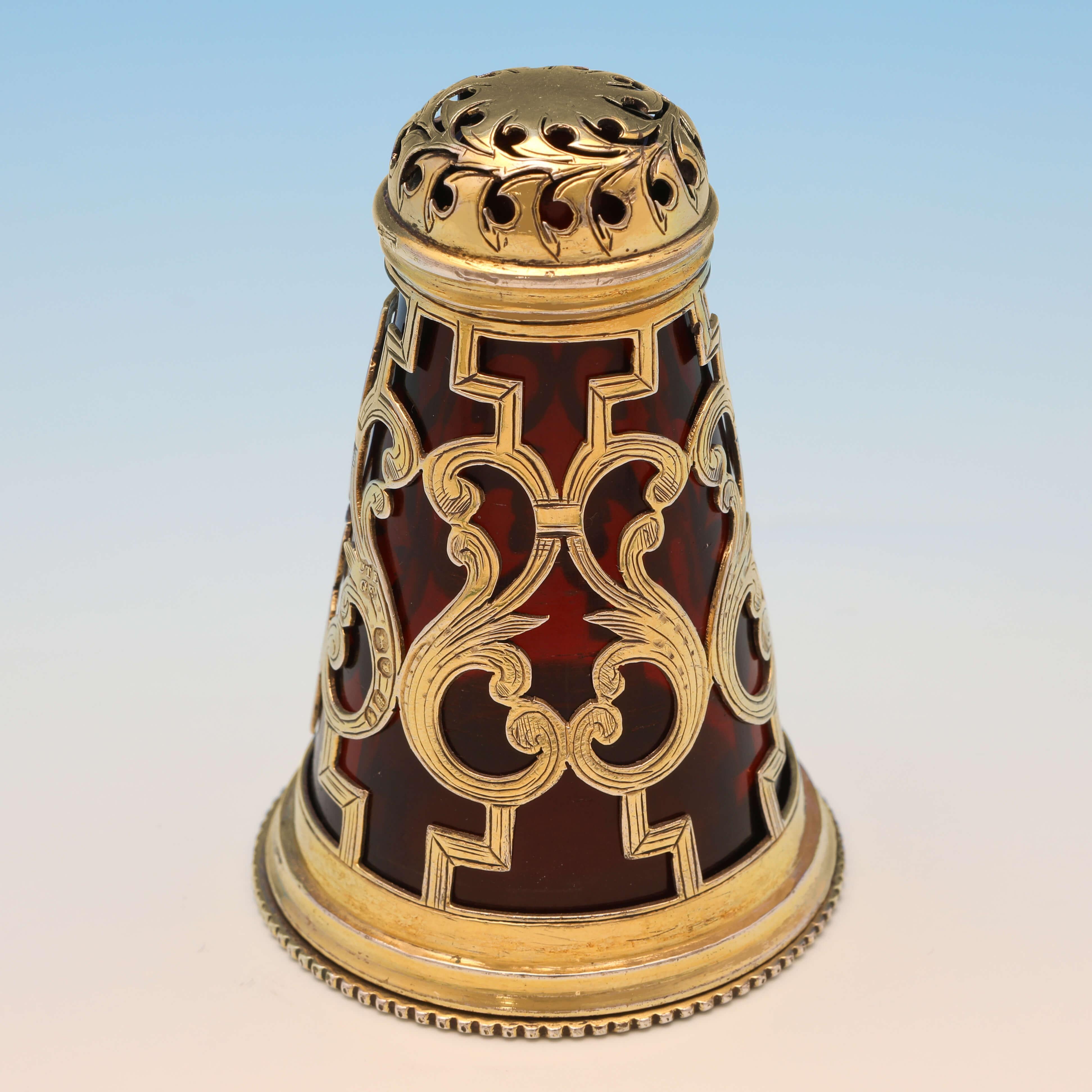 Hallmarked in London in 1850 by Charles & George Fox, this striking, Victorian, antique sterling silver pepper pot, features the original gilding and ruby glass liner, and a pieced and engraved body. The pepper pot measures 2.75